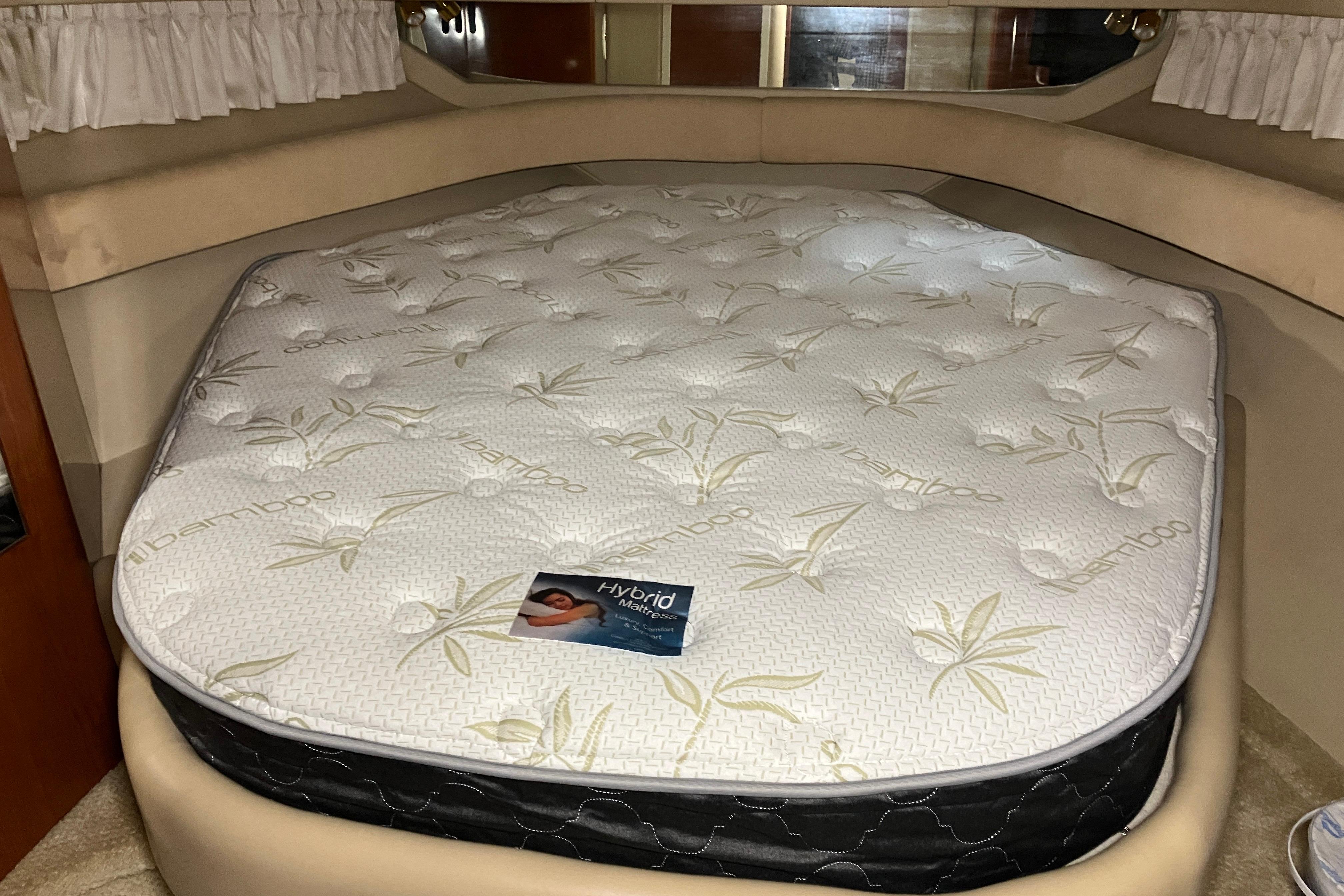 Interior of 2002 Sea Ray 410 Sundancer with bamboo-patterned mattress in cabin.