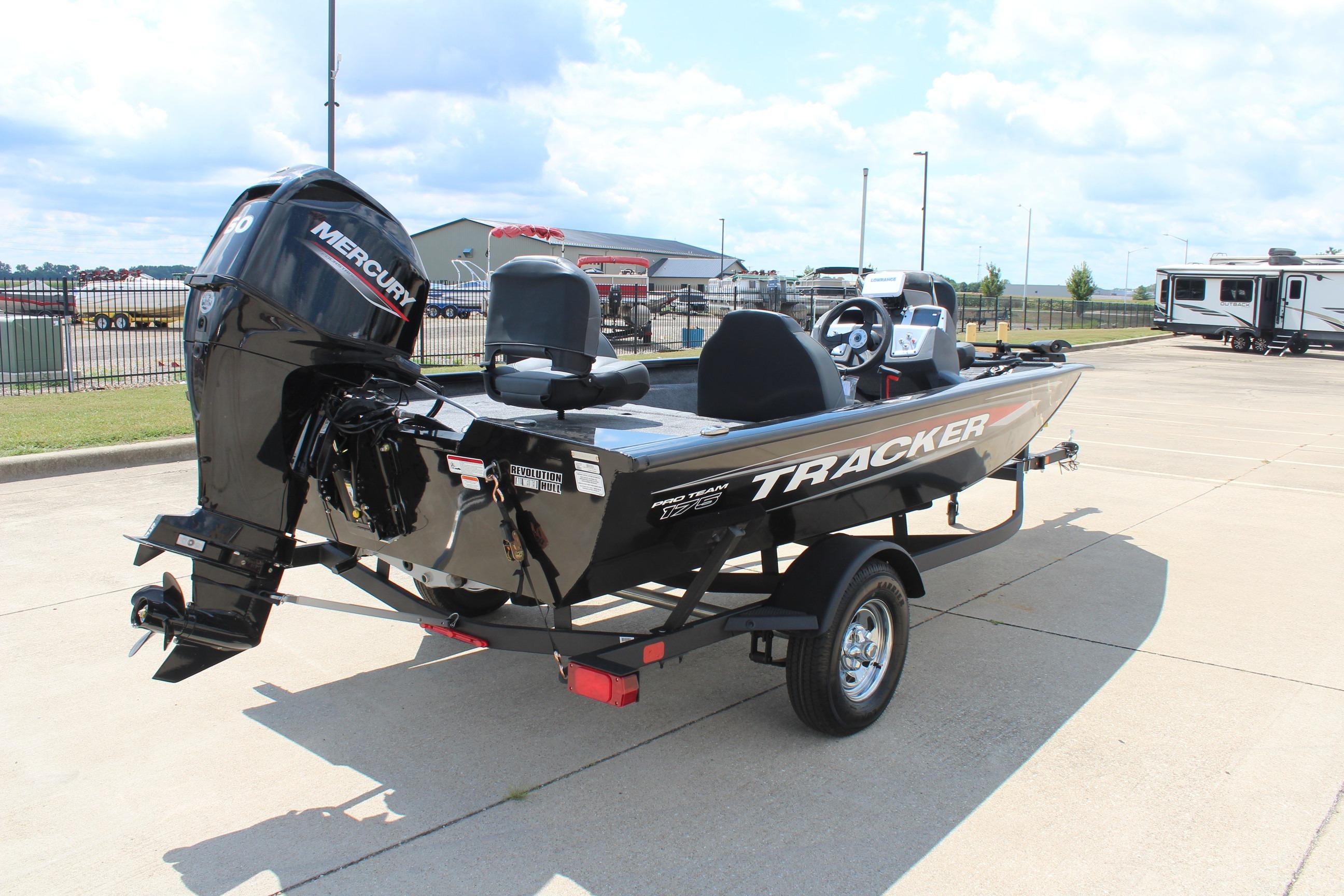 2026 Tracker Pro Team 175 boat with Mercury engine on a trailer in a parking lot.