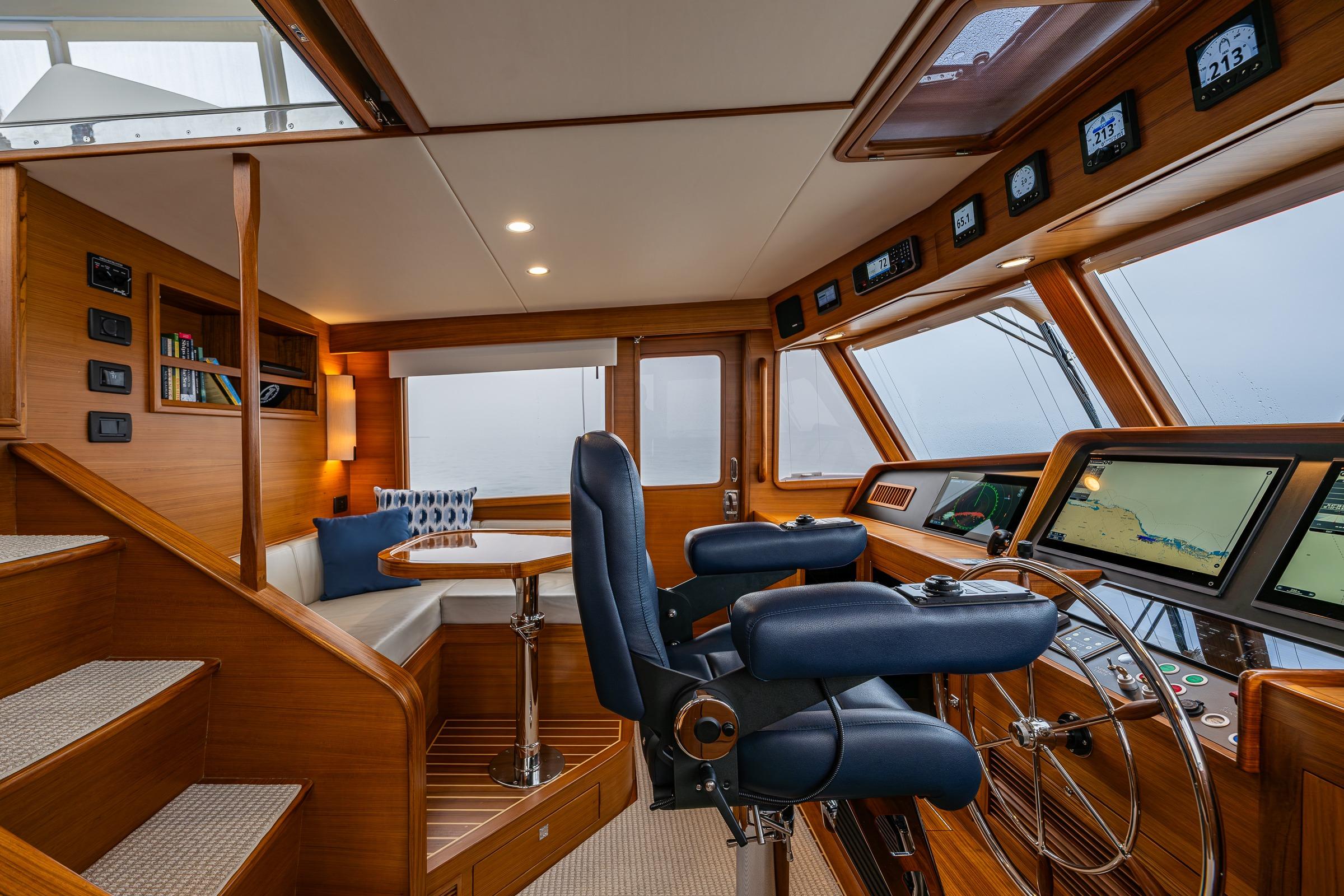 Luxurious 2026 Fleming 55 Pilothouse interior with navigation equipment and seating area.
