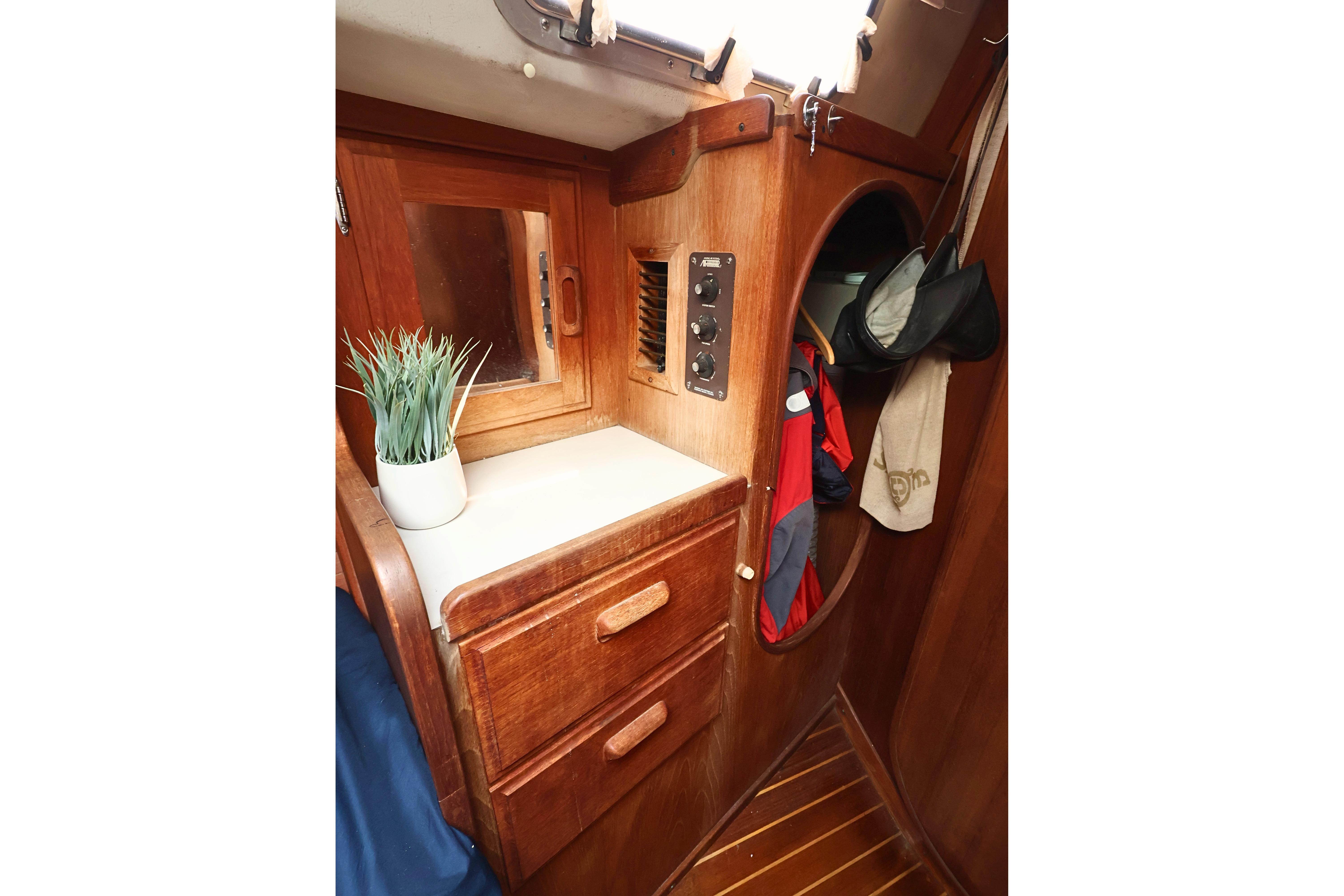 Interior of 1989 J Boat J 40, featuring wooden cabinetry and storage space.