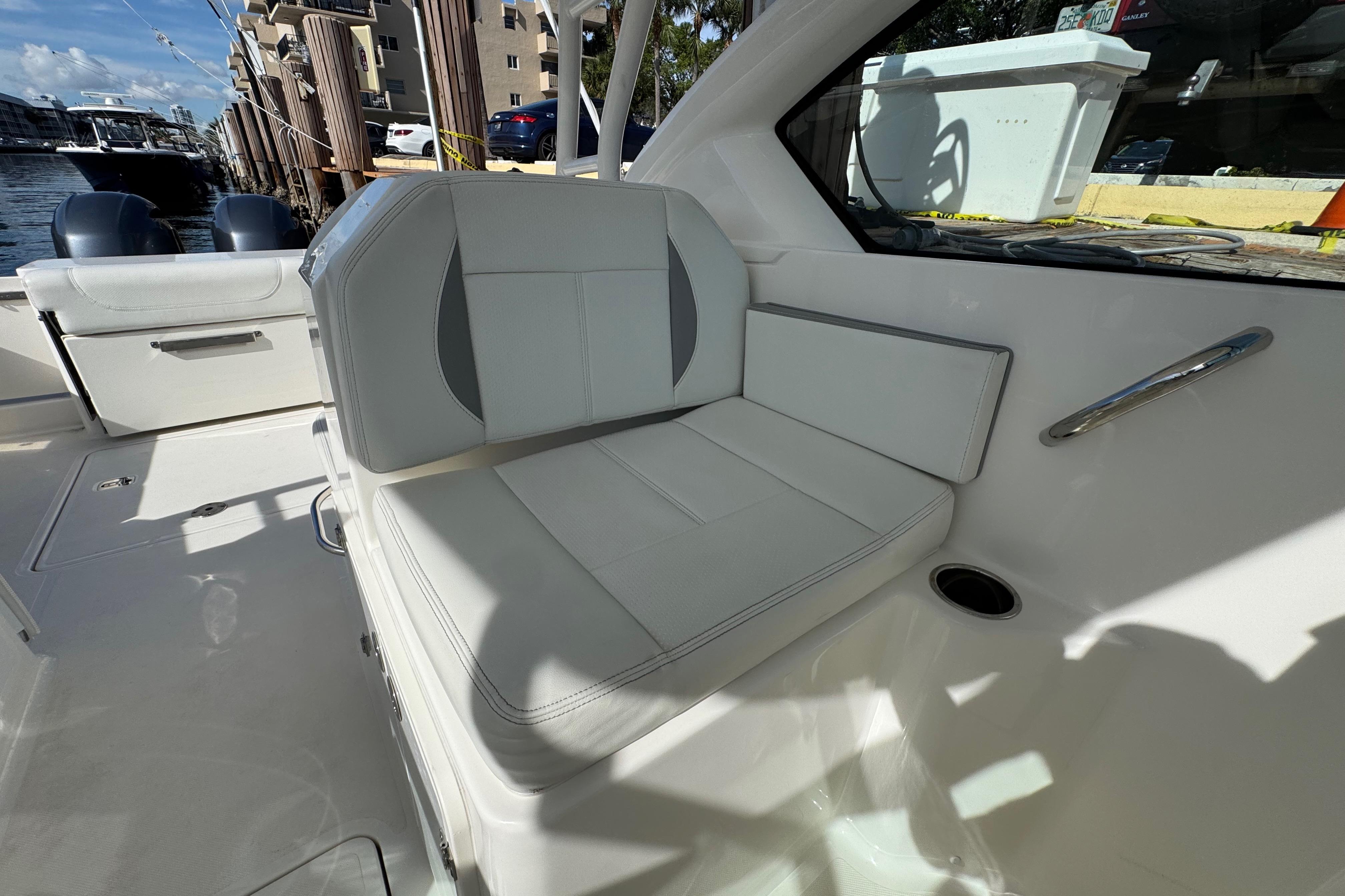 2022 Pursuit DC 266 Dual Console boat interior with white seating and docked view.