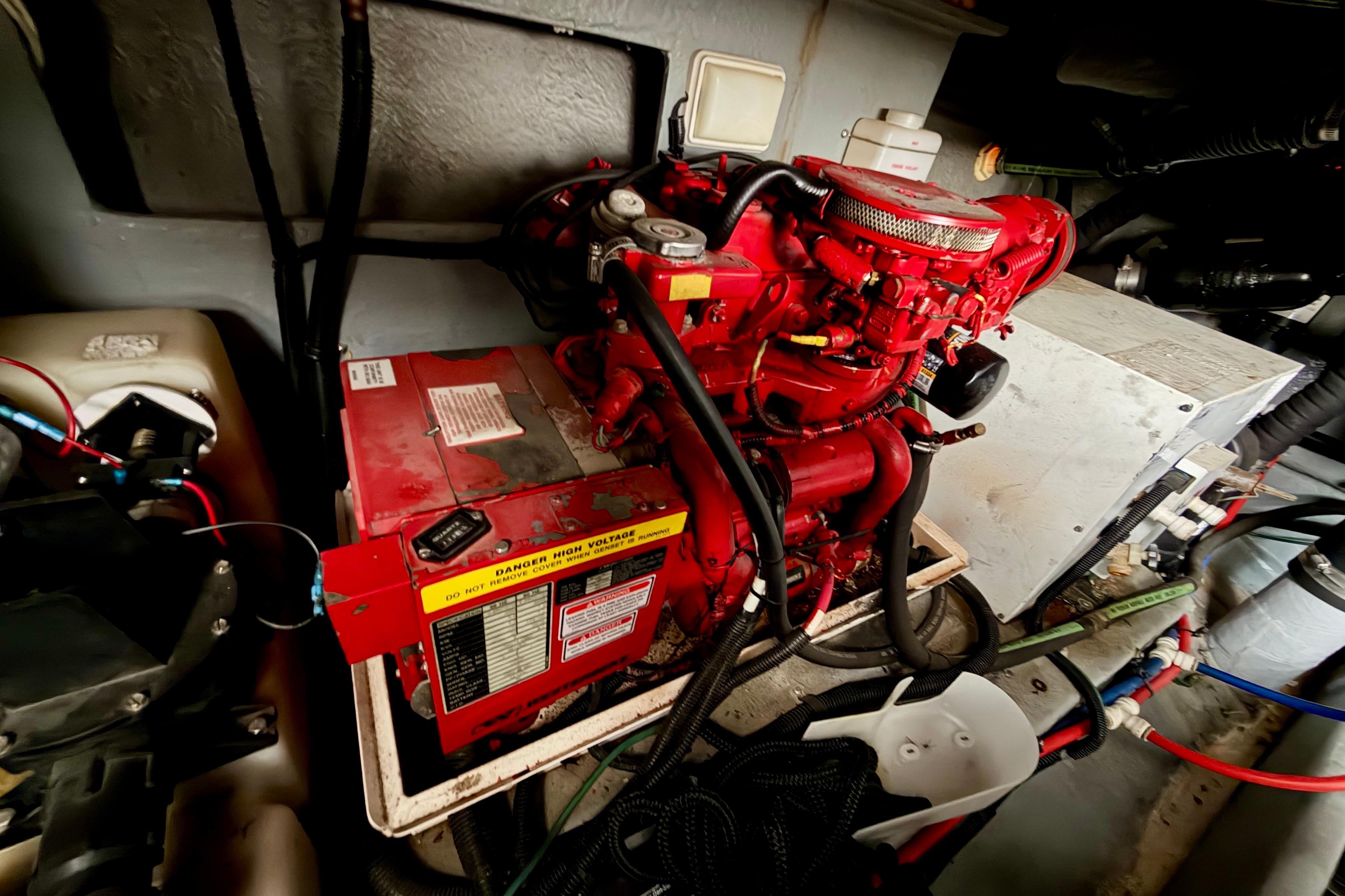 Engine room of 1999 Sea Ray 400 Sundancer with red machinery and wiring.