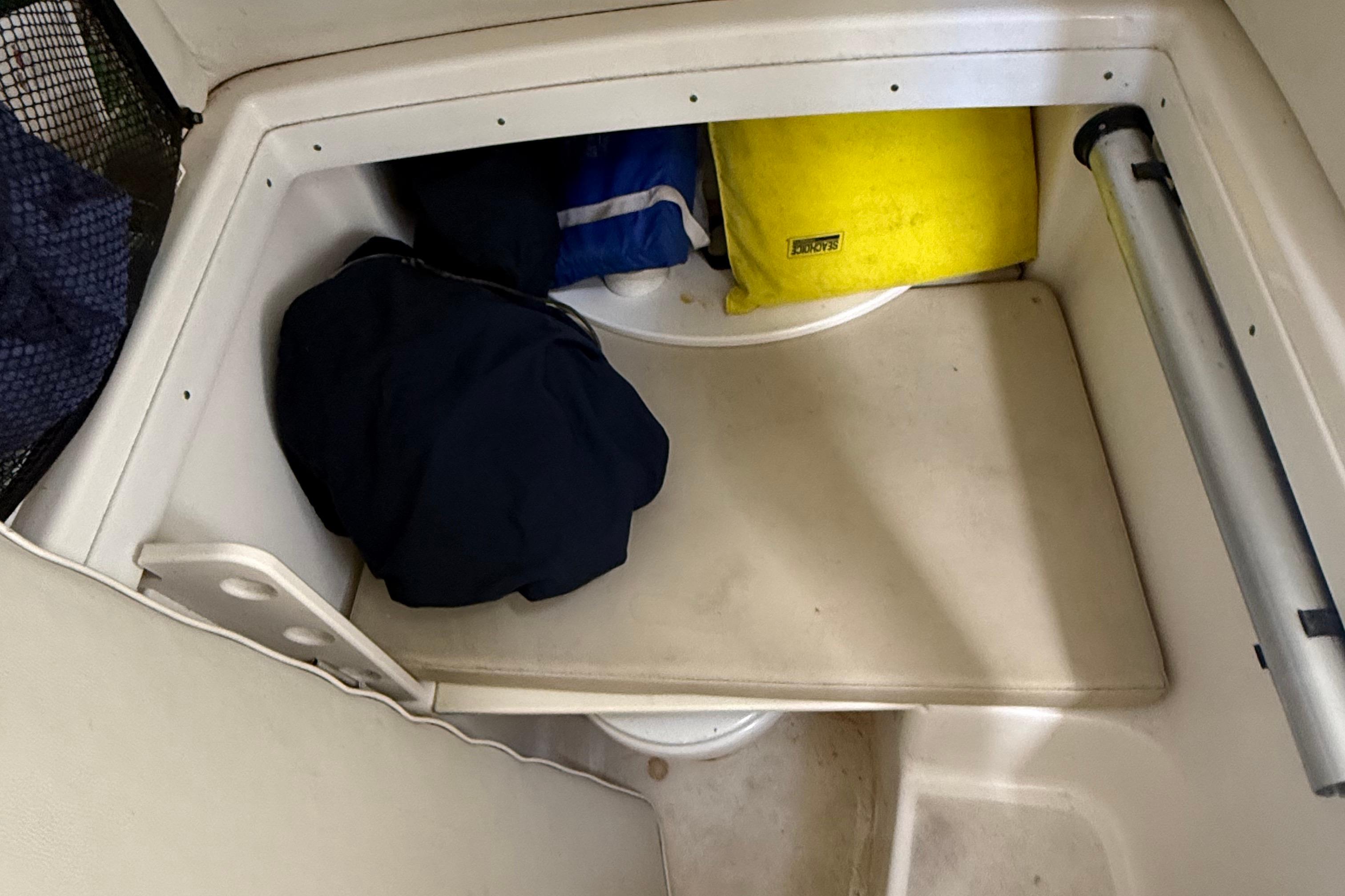 Storage compartment in a 2008 Century 2901 Center Console boat with gear and equipment.
