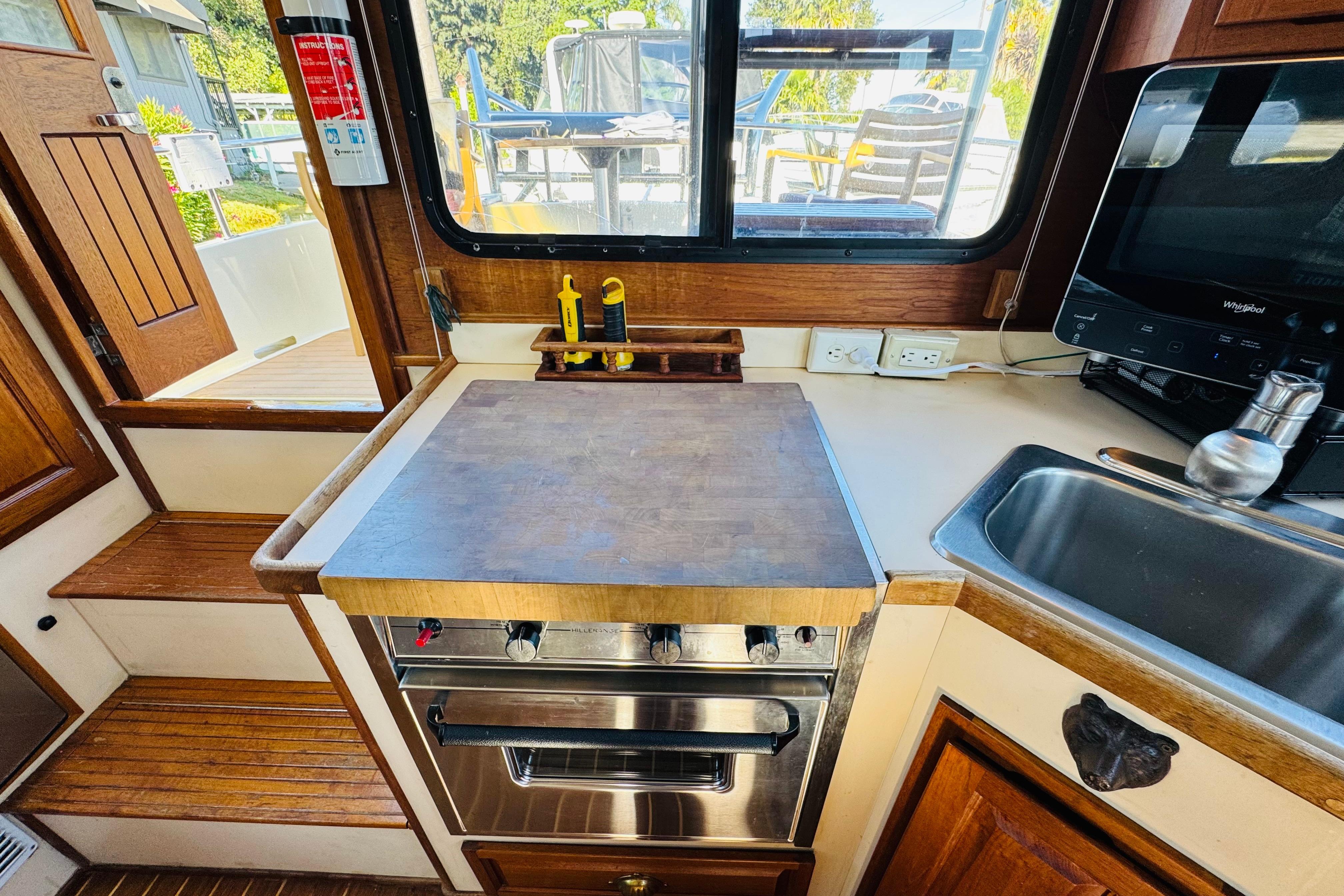 Interior of a 1996 Nordic Tug 32, featuring a compact kitchen area.