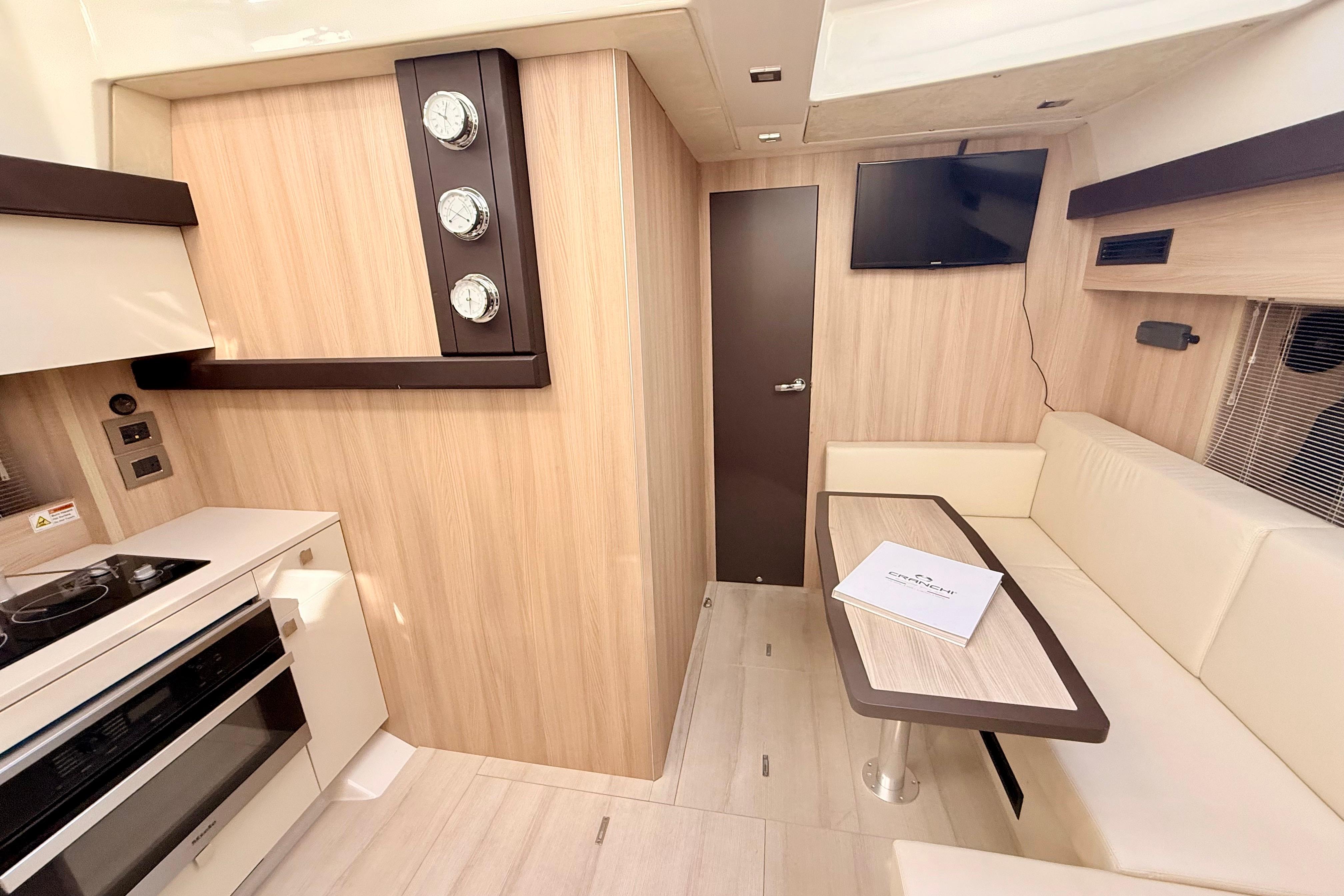 Luxurious interior of 2016 Cranchi M44 HT yacht with modern kitchen and seating area.