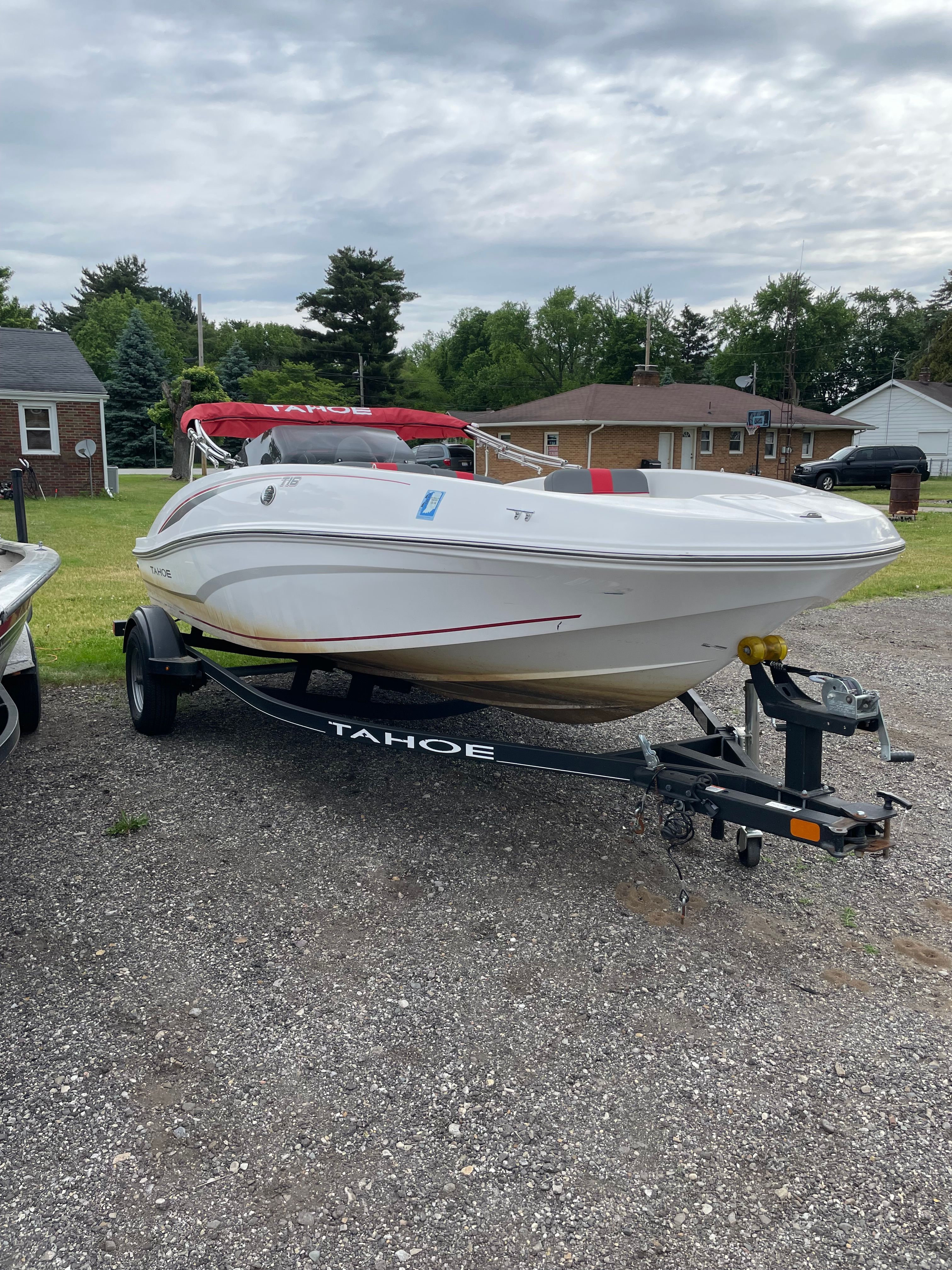 2022 Tahoe T16 boat parked on trailer outdoors.