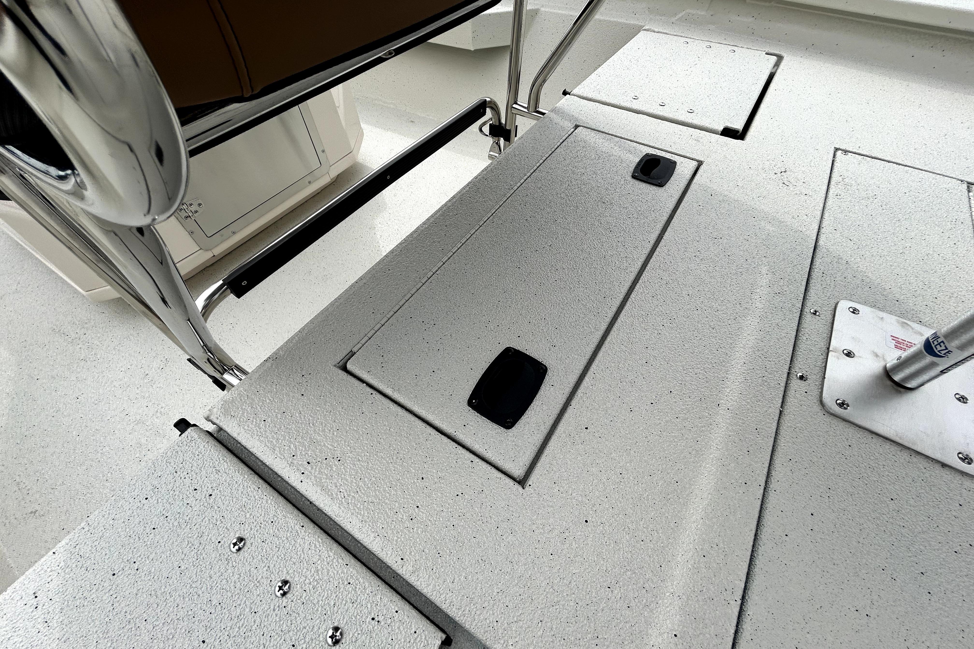 2026 Xpress H20B Bay boat deck with storage compartments and stainless steel fittings.