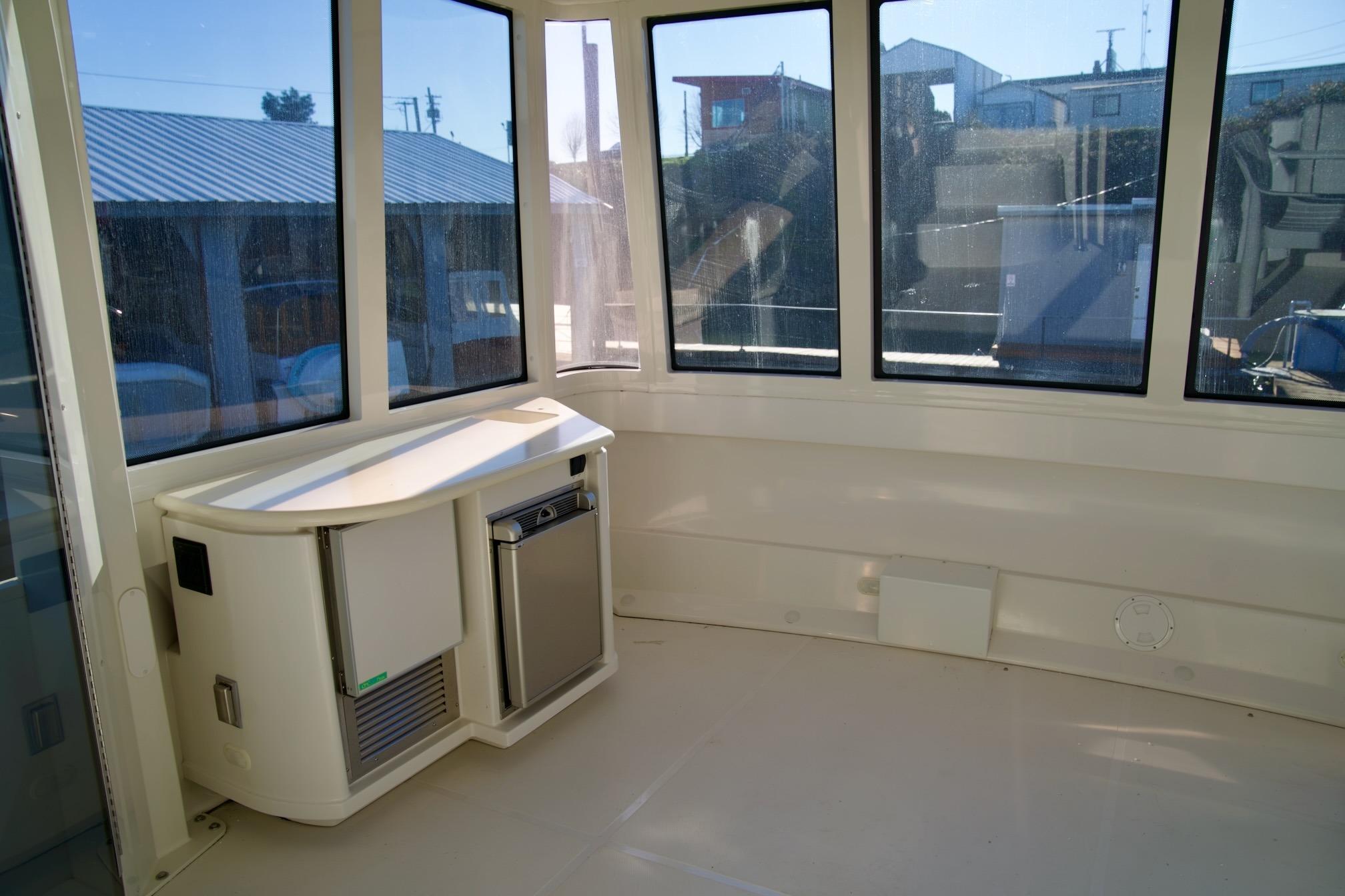 Interior of 2000 Carver 506 Motor Yacht with windows and compact kitchenette.