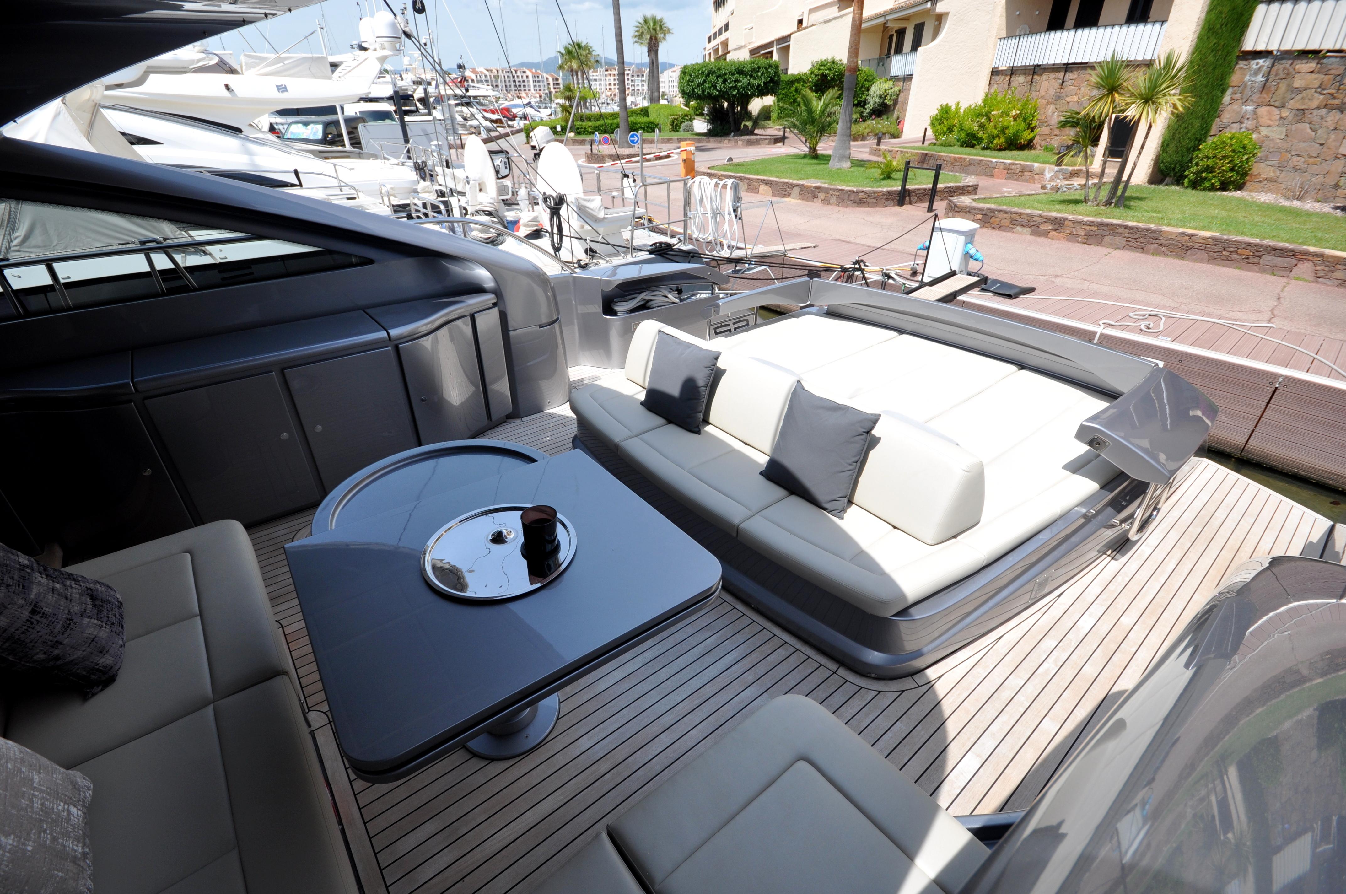 Luxurious 2020 Pershing 62' yacht deck with elegant seating and table setup.