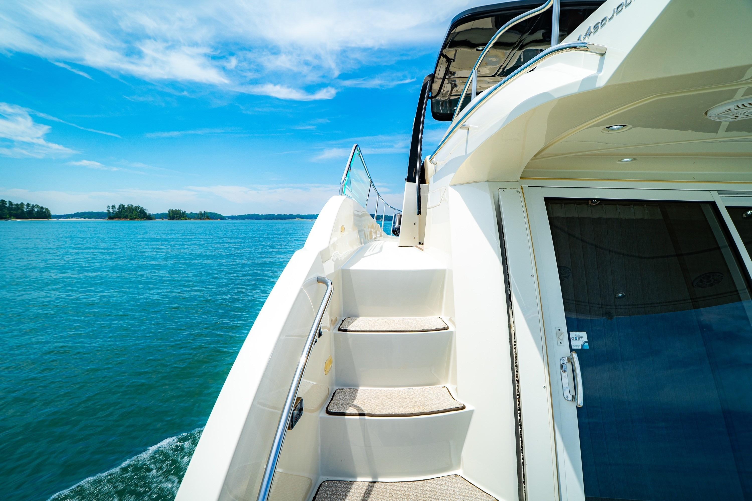2011 Carver 44 Sojourn yacht on serene blue waters under a clear sky.
