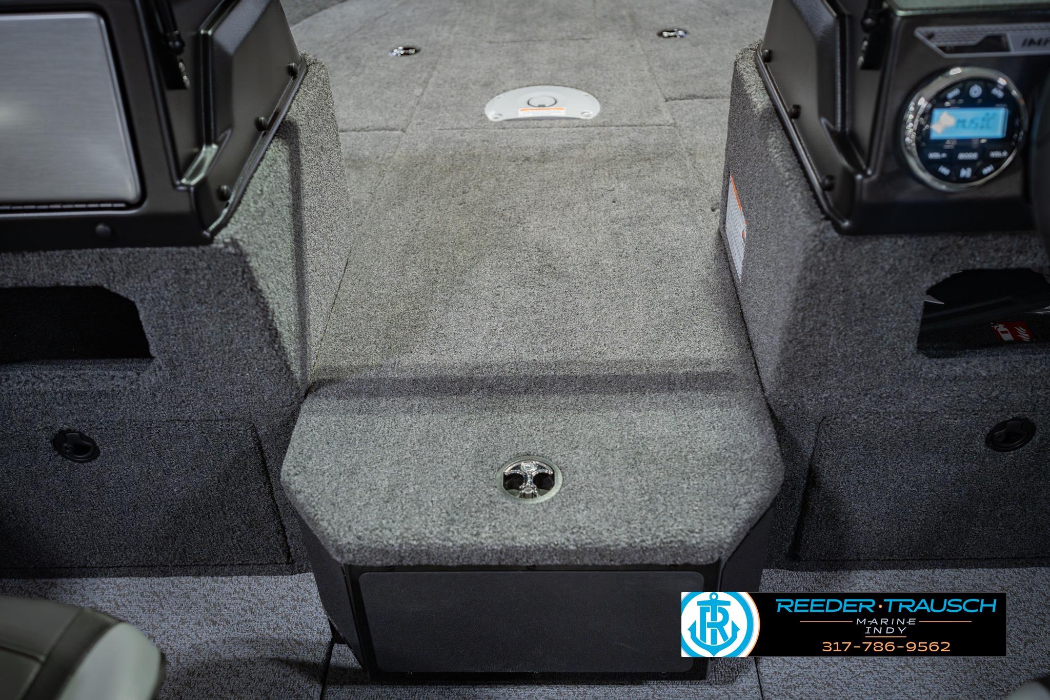 2026 Lund 1775 Impact XS boat interior with carpeted flooring and dashboard controls.