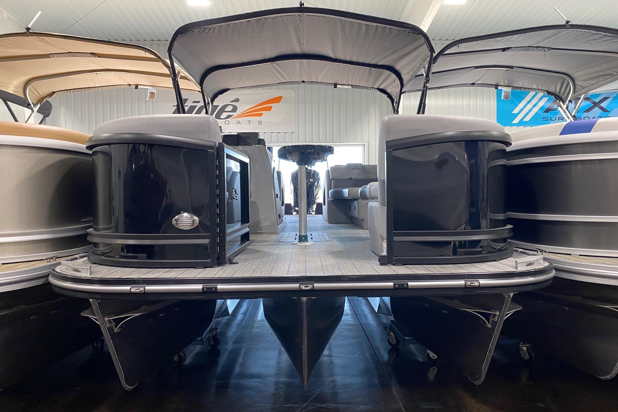 2026 SunCatcher Fusion 324SS pontoon boat displayed in showroom, featuring sleek design and canopy.