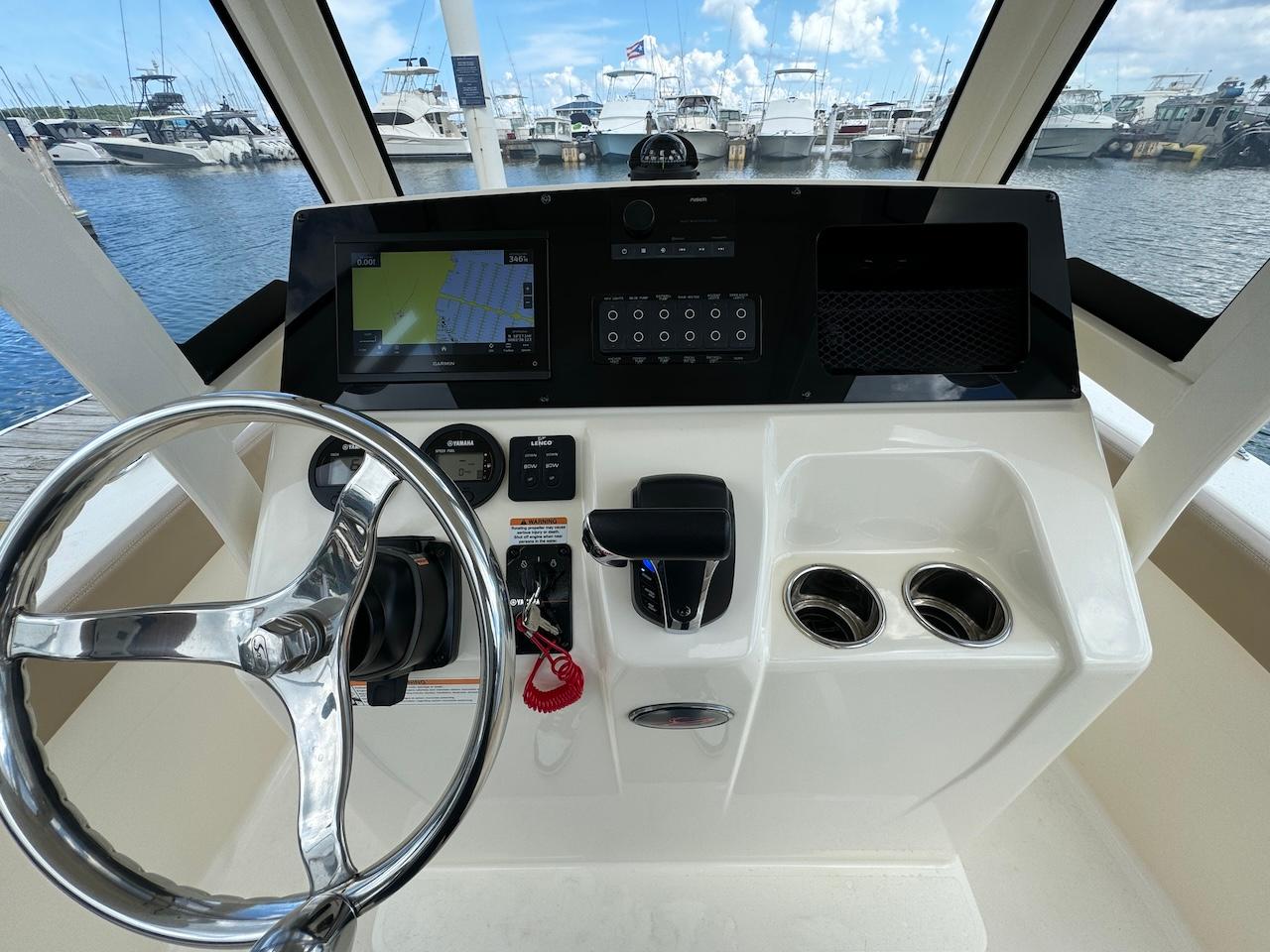 2023 Scout 215 XSF boat dashboard with steering wheel and navigation system.