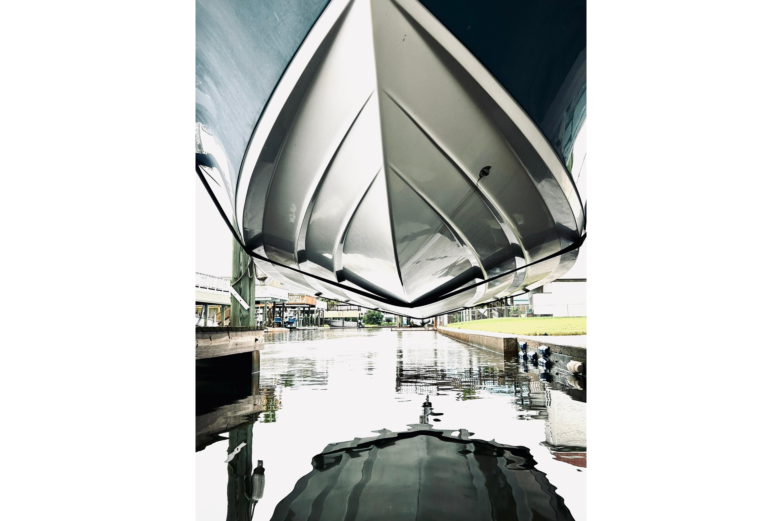 Underside view of a 2017 Blue Wave 2200 PureBay boat above water.