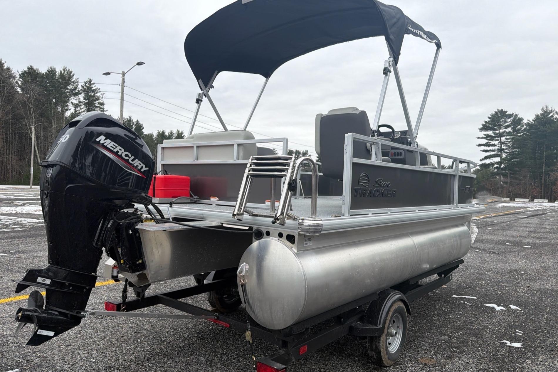 2026 Sun Tracker Bass Buggy 16 XL Select pontoon boat with Mercury outboard motor.