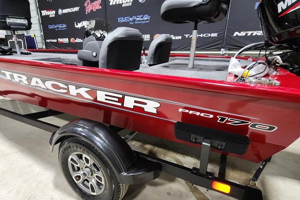 2026 Tracker Pro 170 boat in showroom, red exterior, on trailer.