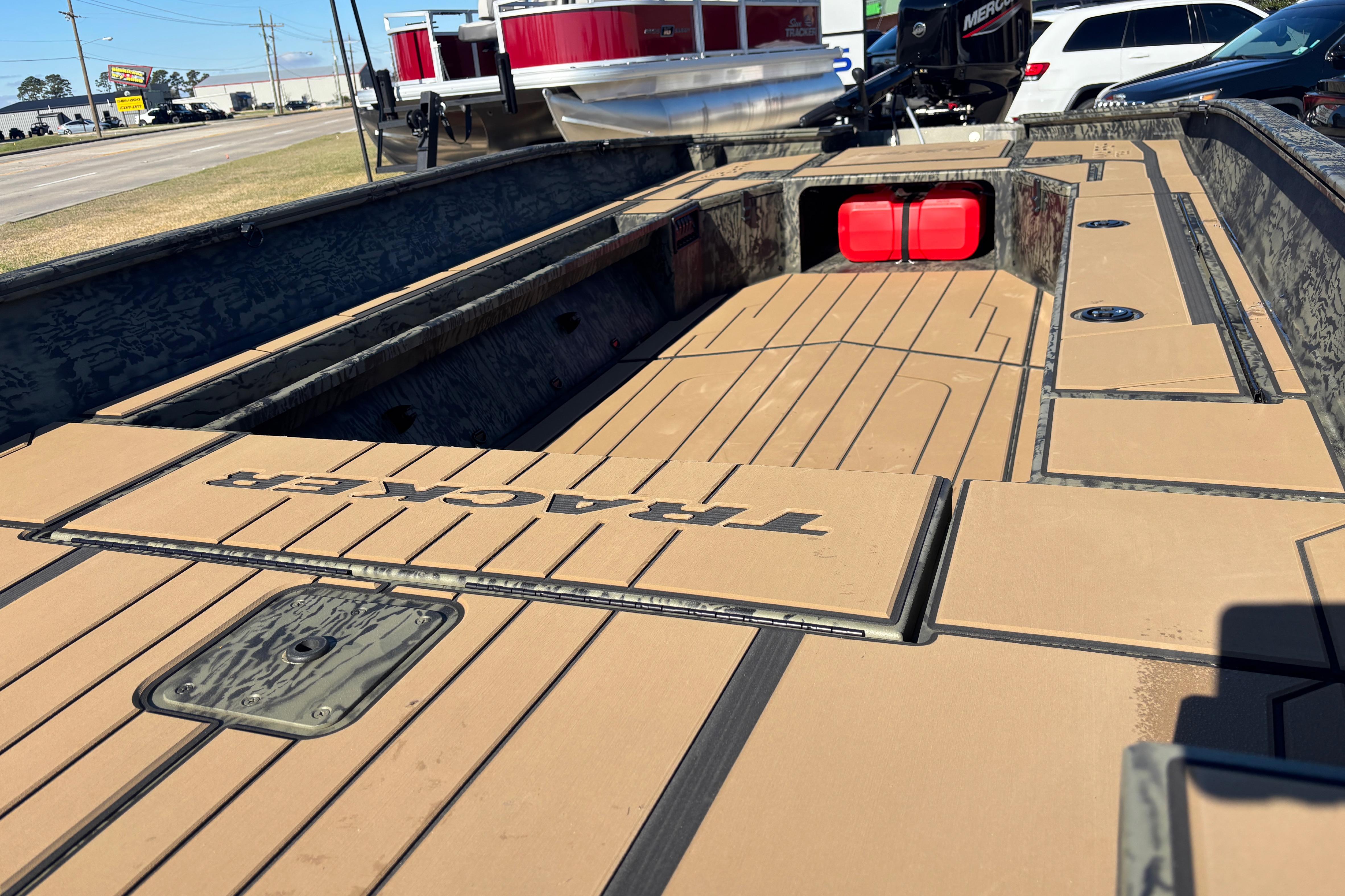 2026 Tracker Grizzly 1756 T Marsh boat interior with tan decking and storage compartments.