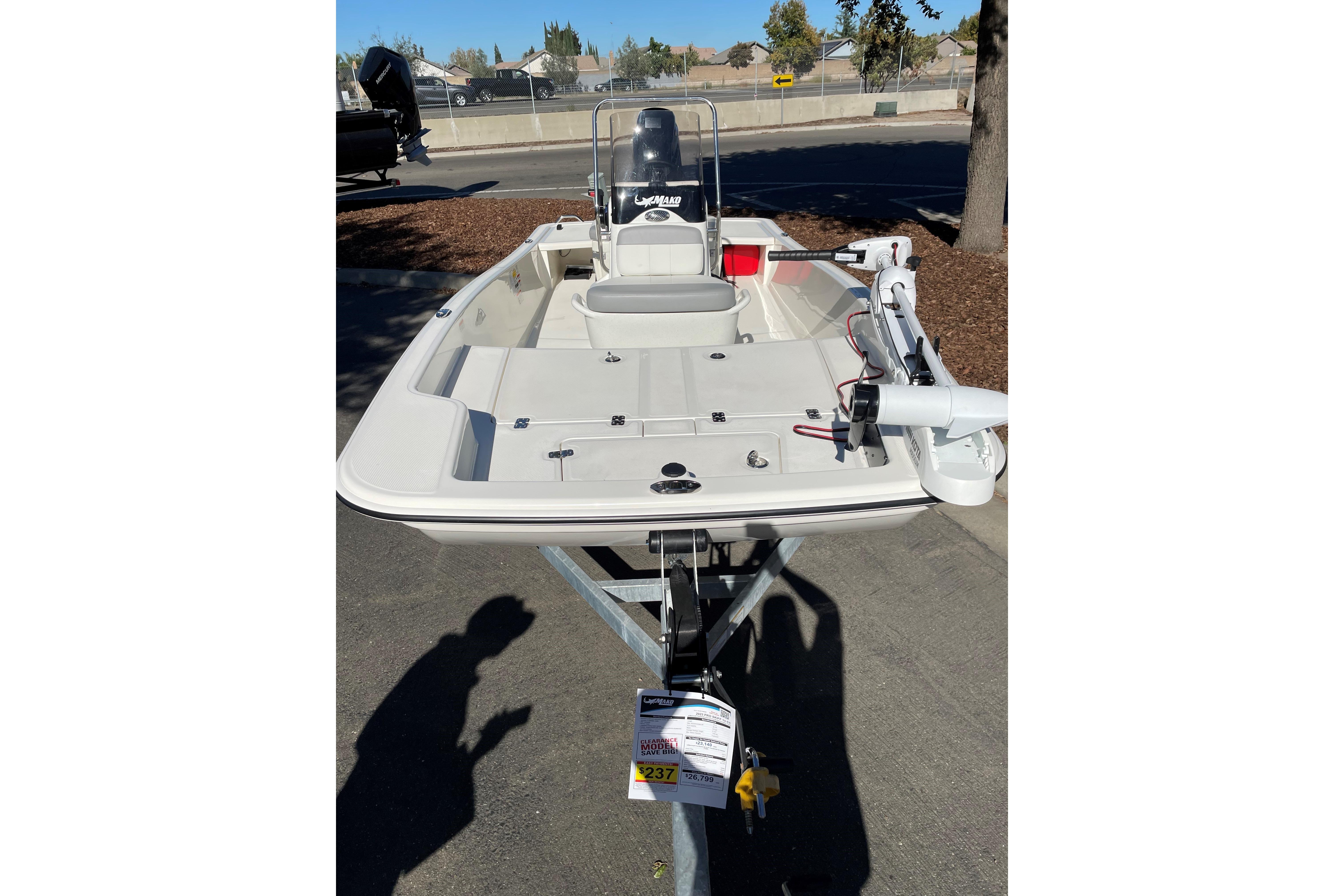 2025 Mako Pro Skiff 15 CC boat on trailer, parked outdoors.