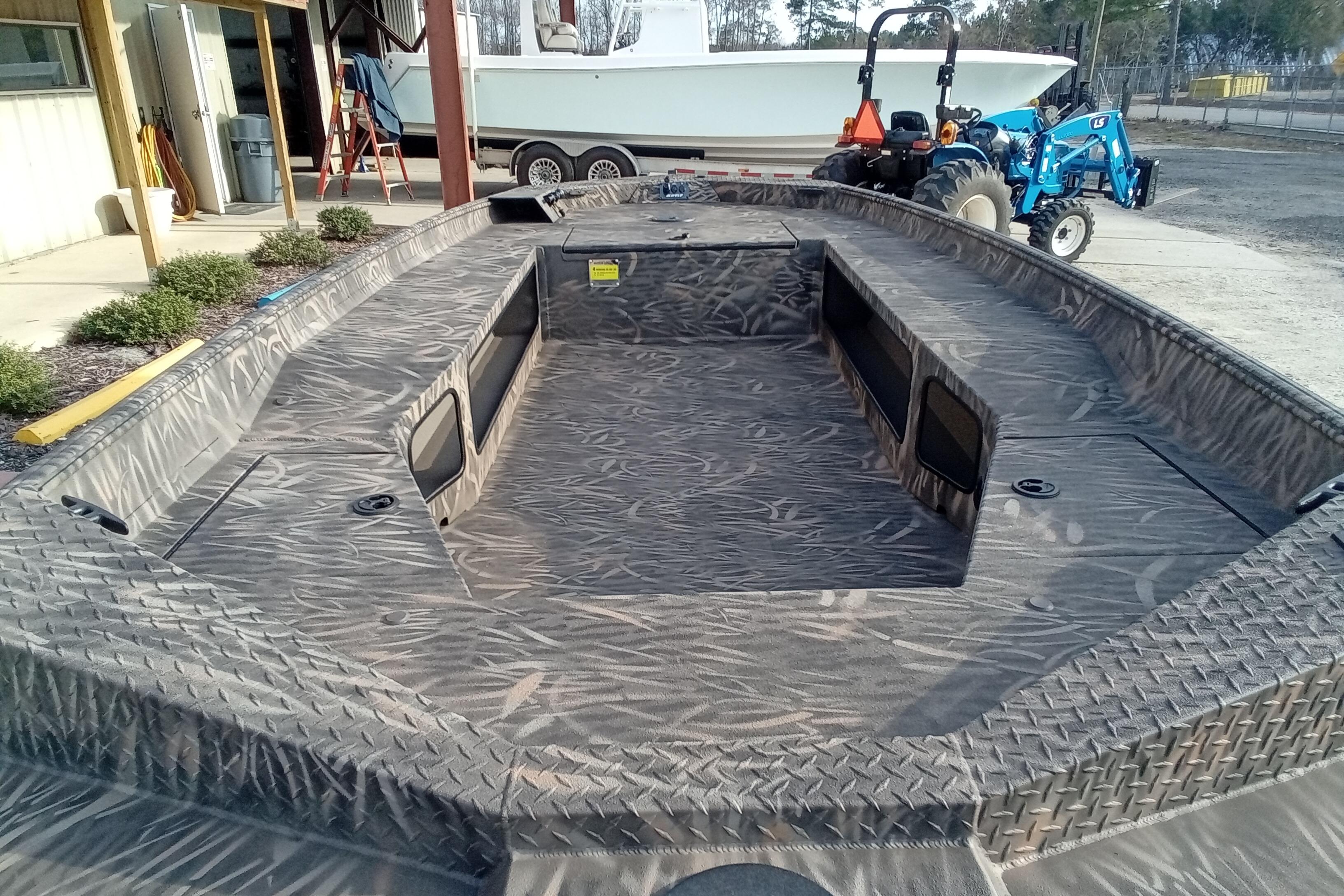 2026 Alweld 1756 Invader boat with camo interior, parked outdoors.