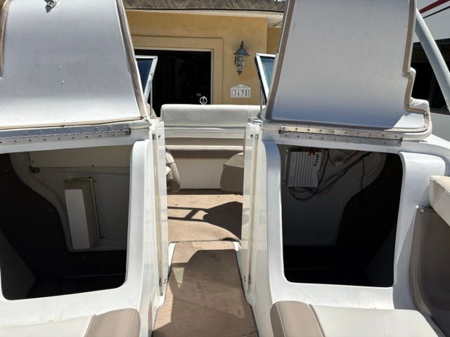 Interior view of a 2000 Cobalt 206 boat with open storage compartments.