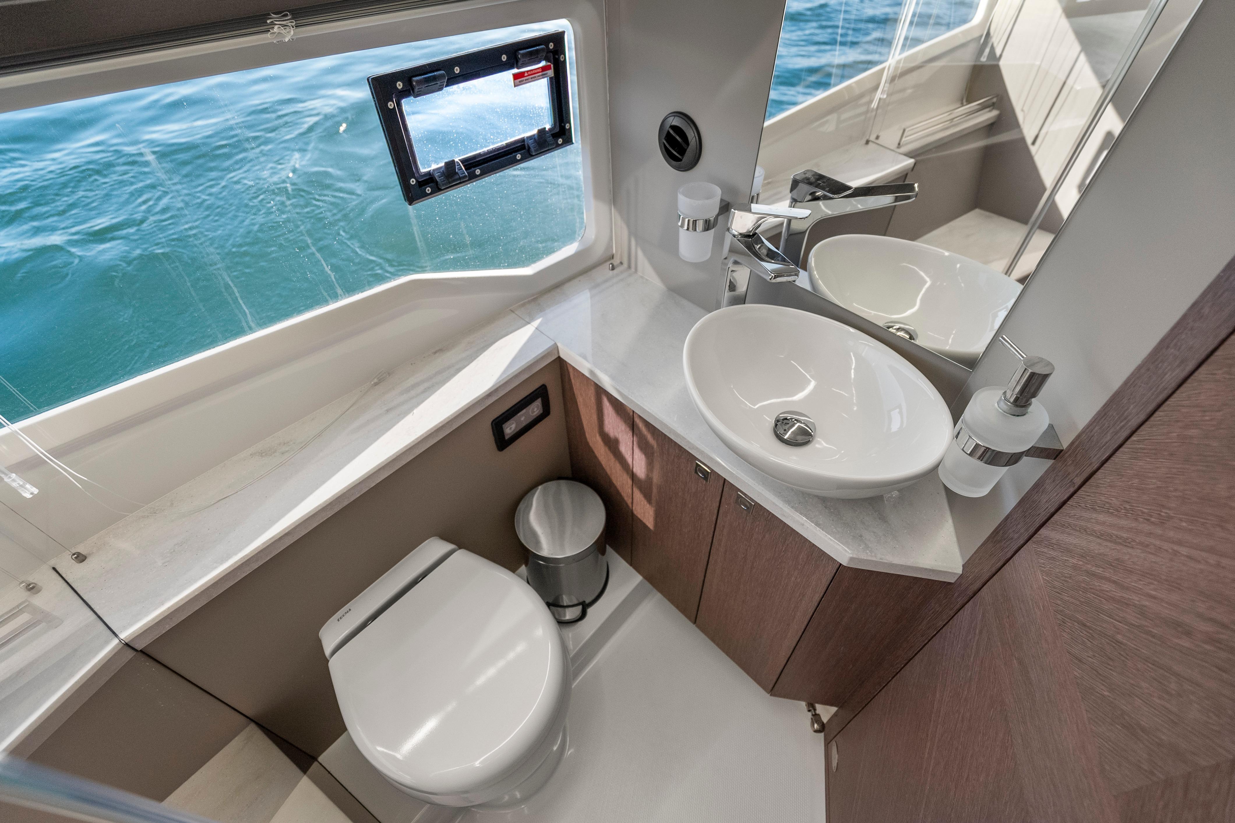 Luxurious bathroom interior of 2023 Galeon 400 Fly yacht with ocean view.