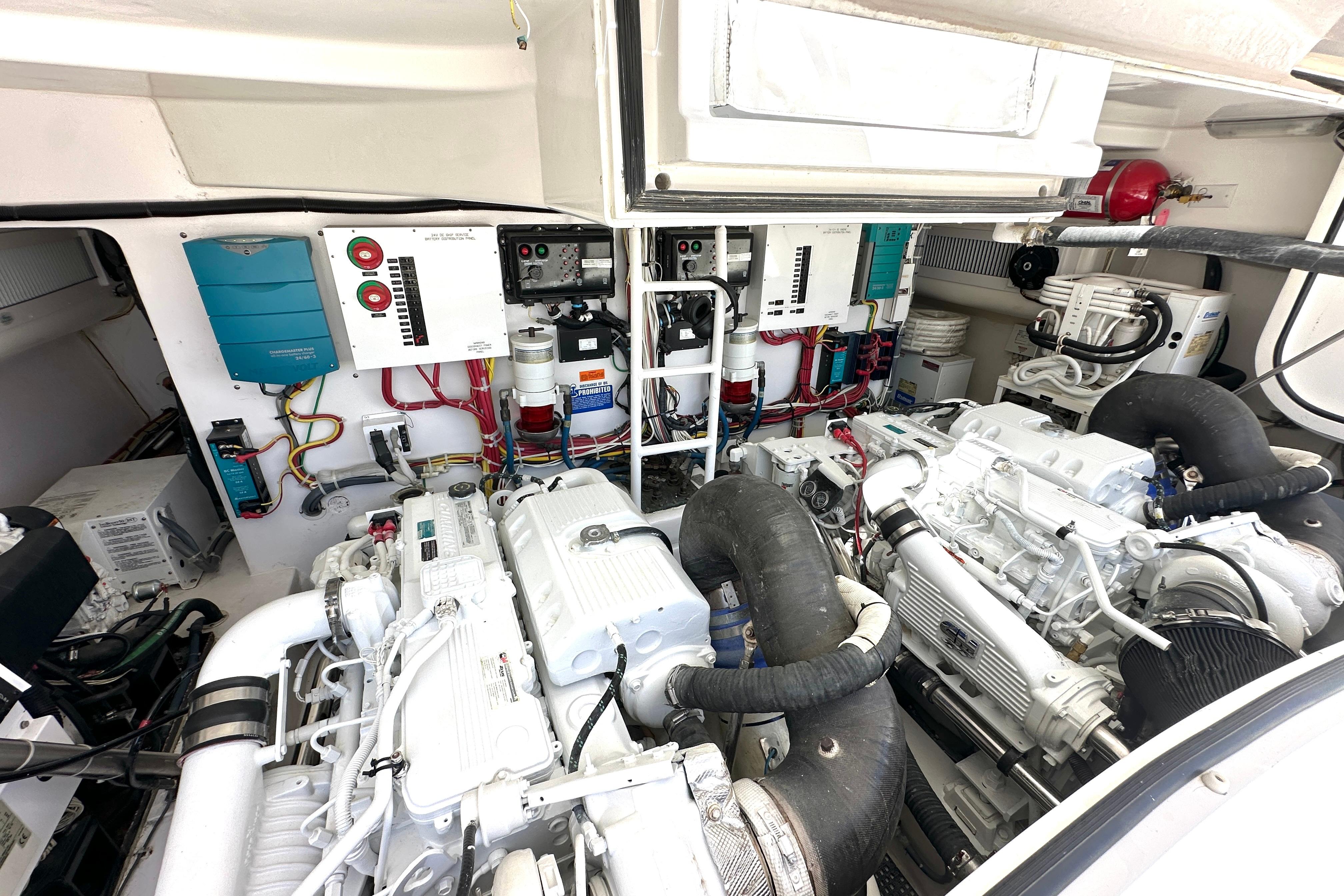 Engine room of a 2012 Viking 42 Open yacht, showcasing dual engines and control systems.