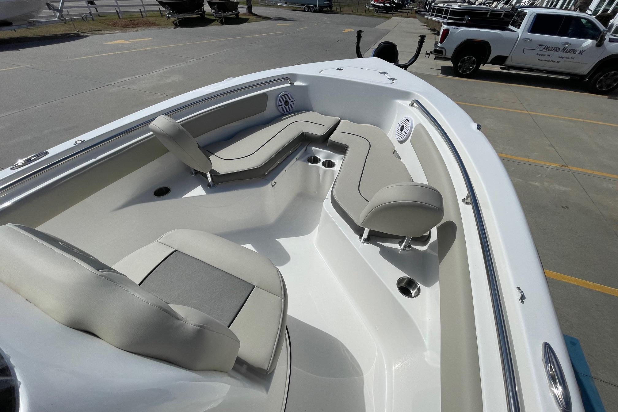 2026 Key West 203 FS boat interior with cushioned seating and cup holders.