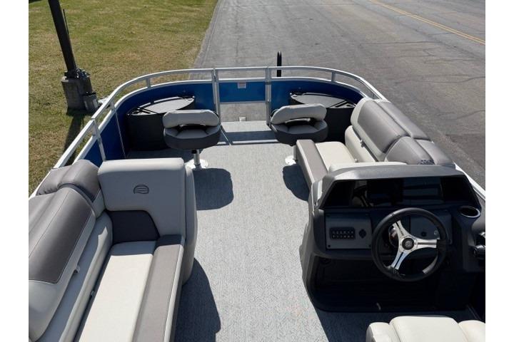 2026 Sun Tracker Fishin' Barge 20 DLX interior with seating and steering console.