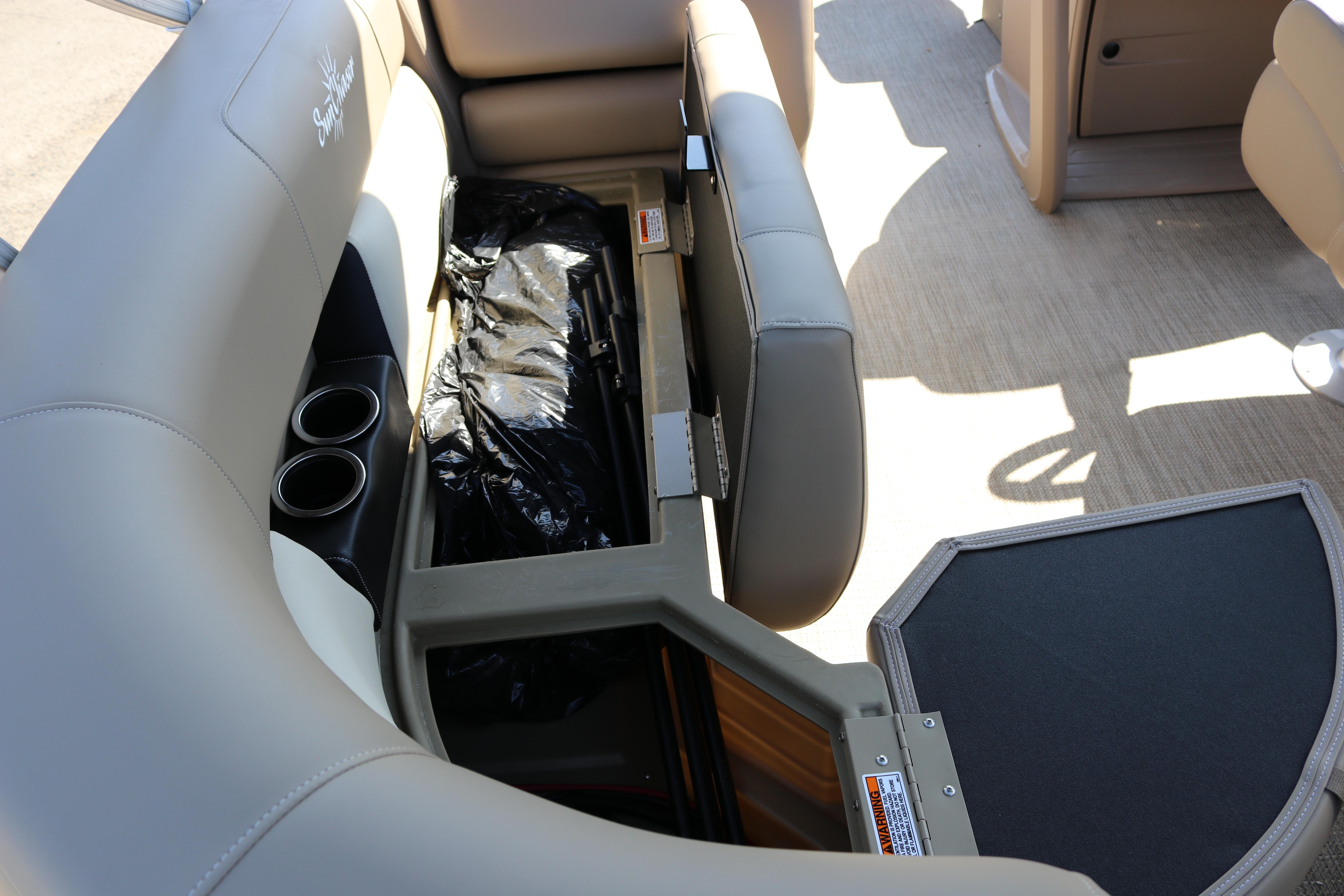 Sun Chaser Vista Fish 18 boat interior with storage compartment and cup holders, 2025 model.