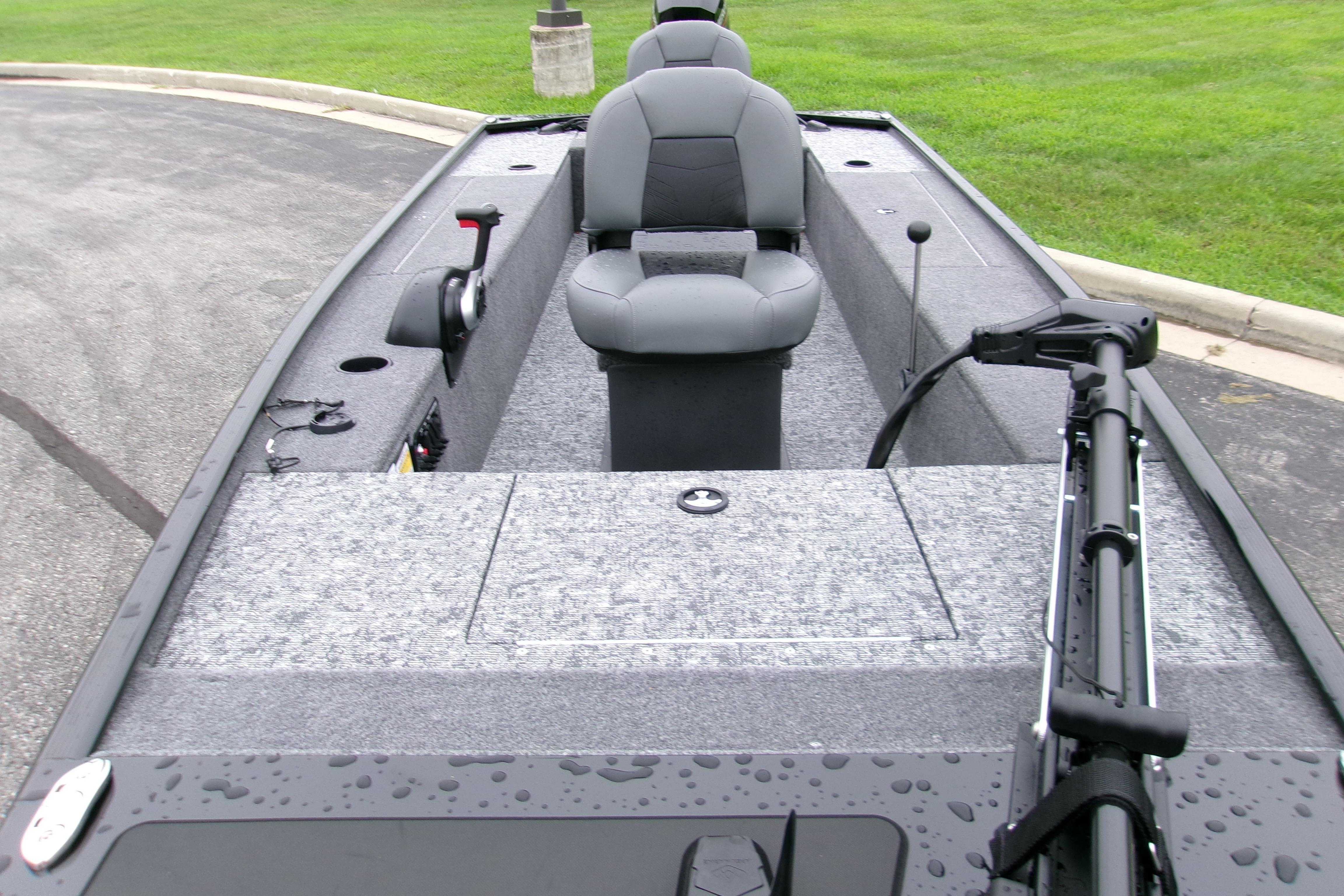 2025 Tracker Panfish 17 boat interior with seating and fishing equipment on a wet surface.