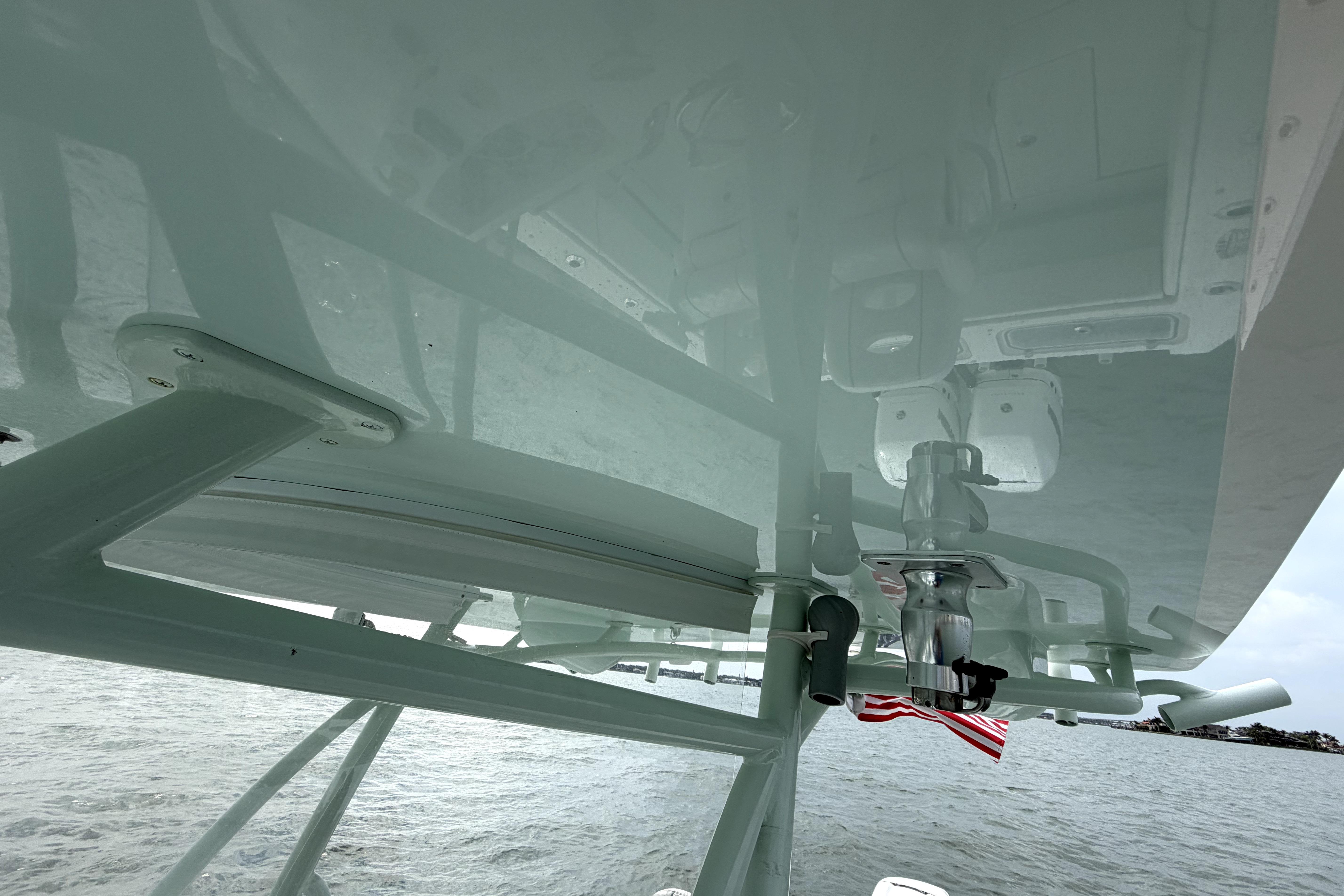 2019 Contender 30 ST boat with T-top and American flag, viewed from below.