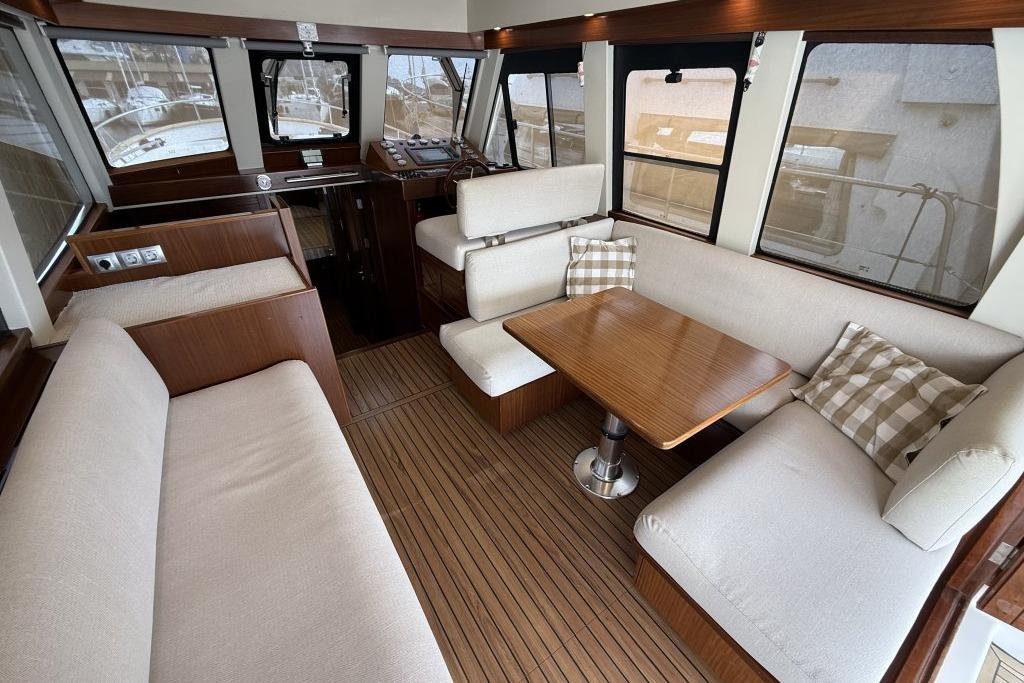 Luxurious interior of 2012 Sasga Yachts Menorquin 42 with elegant seating and wooden table.