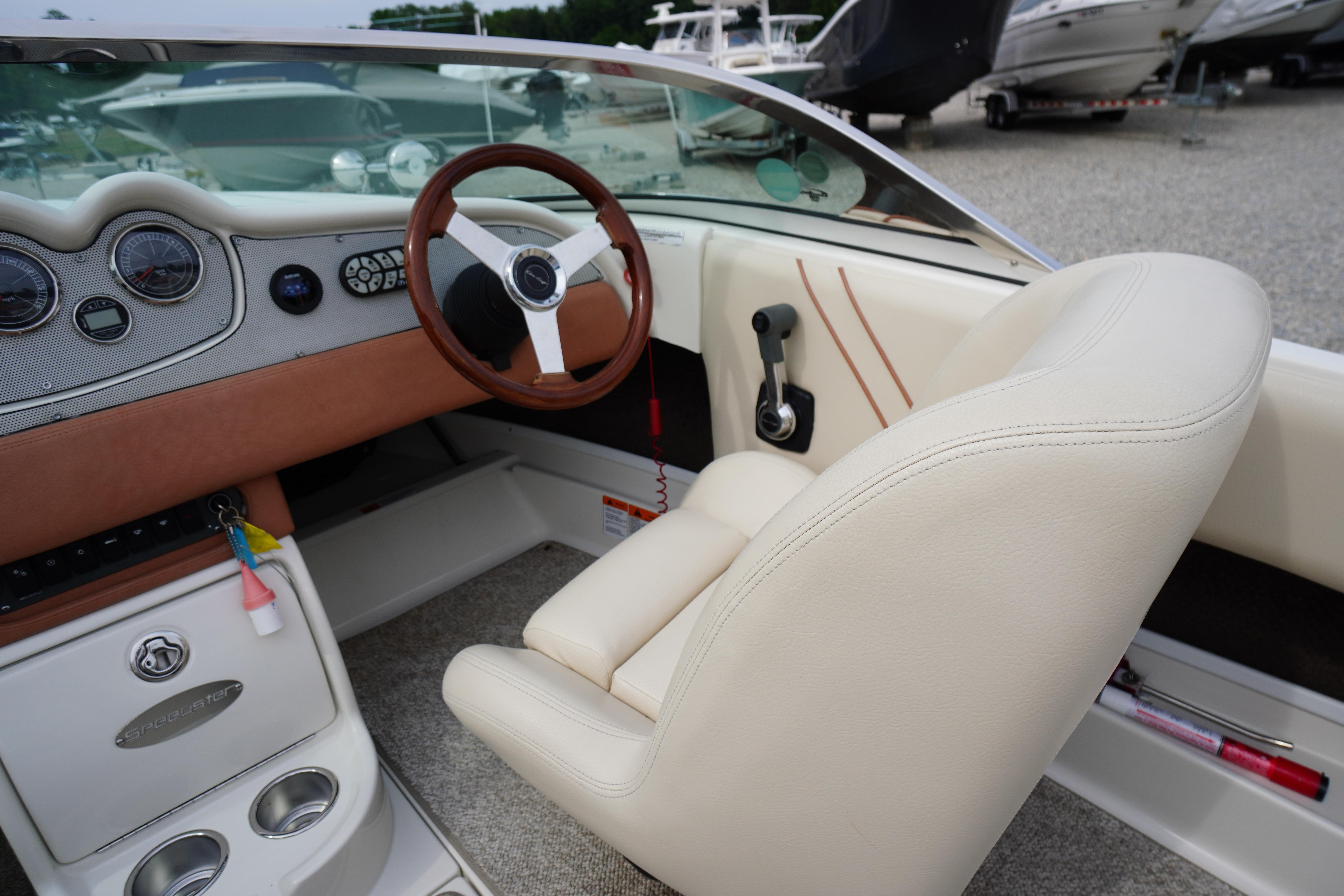 Interior of a 2005 Chris Craft Speedster Heritage boat, featuring a classic steering wheel and dashboard.