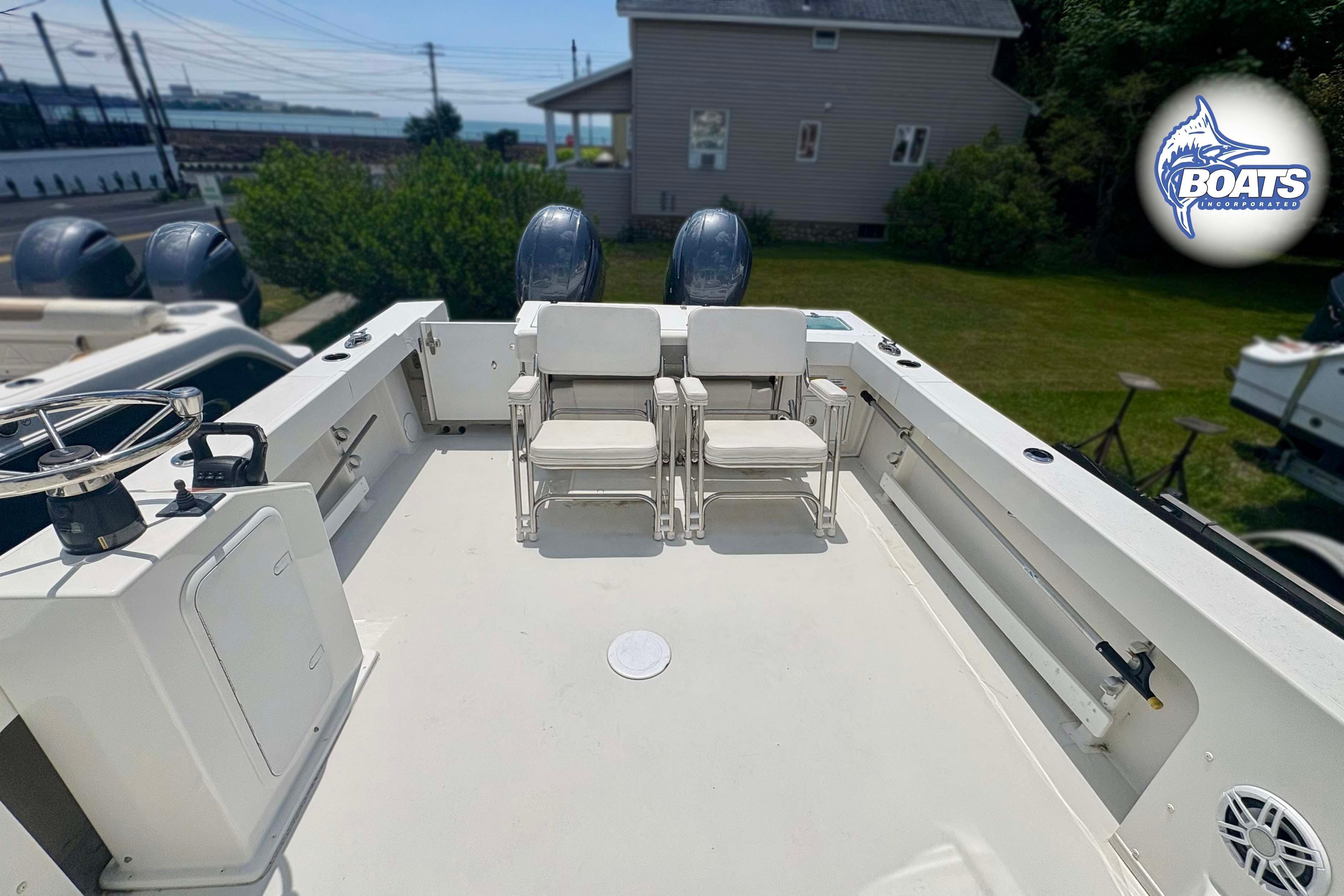 2021 Parker 2520 XLD Sport Cabin boat deck with seating and dual engines.