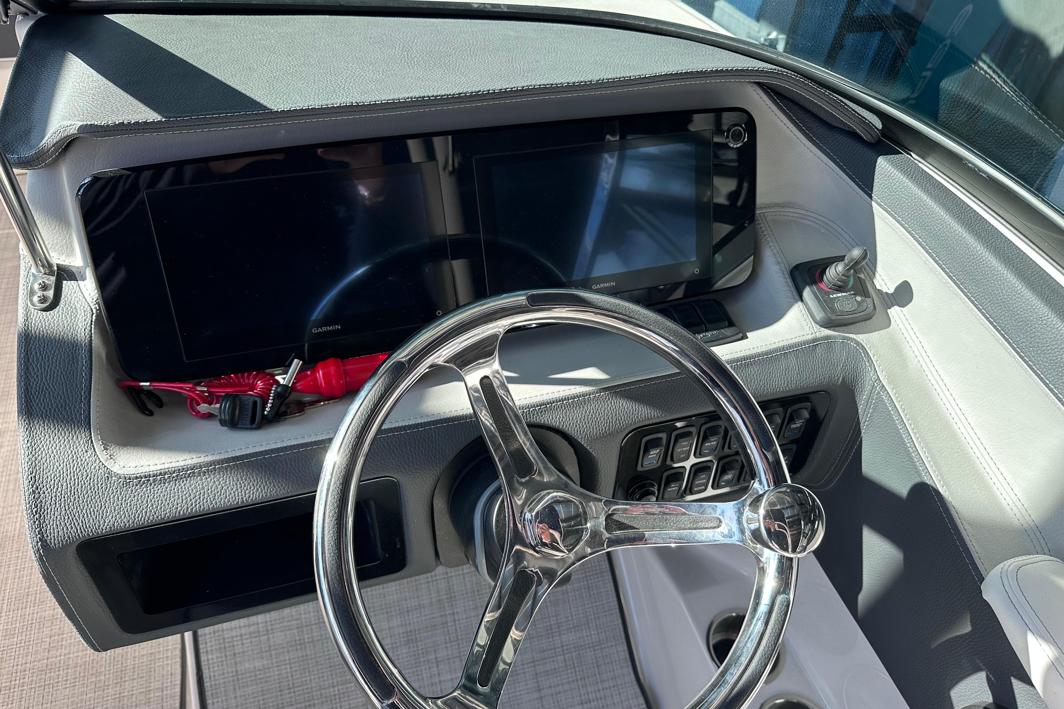 2026 Regal LX4 boat dashboard with steering wheel and digital displays.