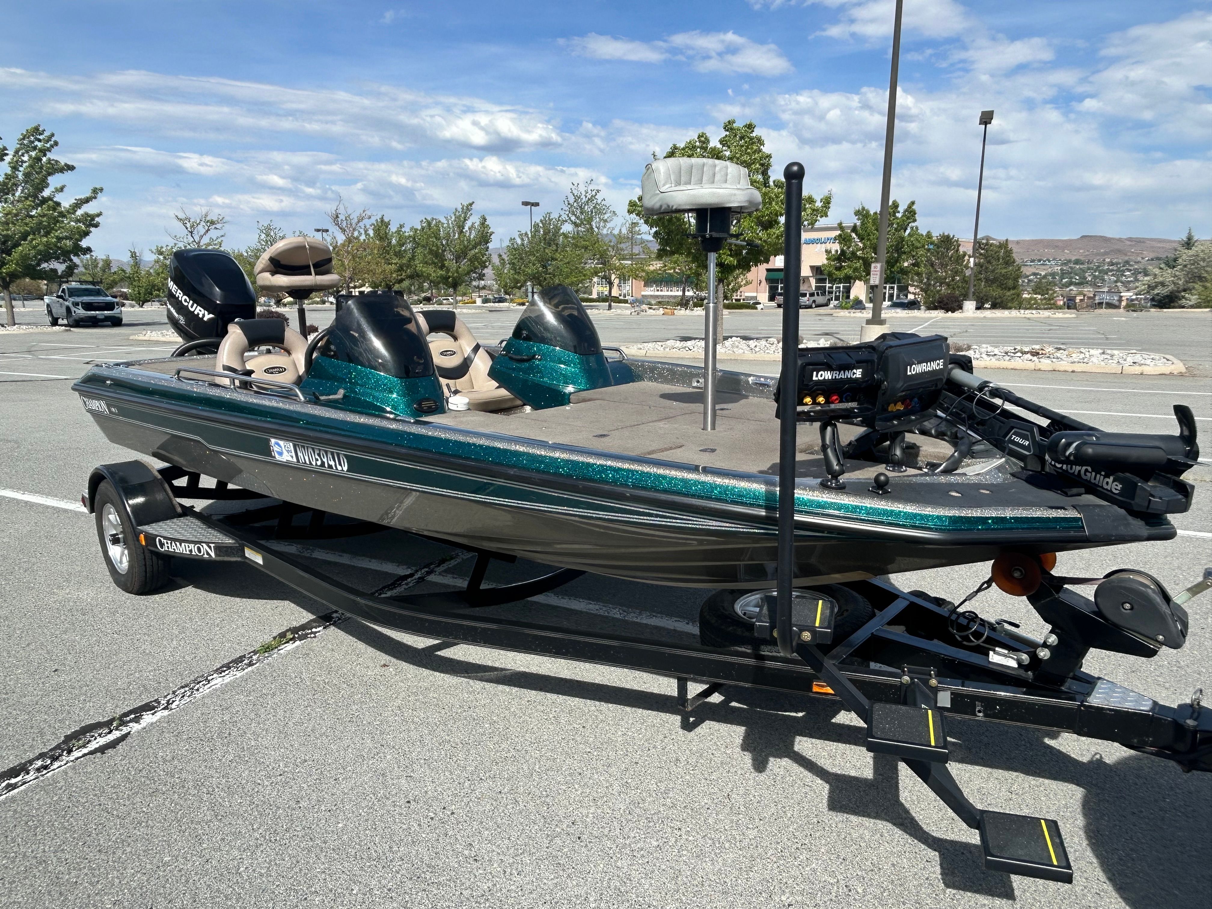 2008 Champion 183 boat on trailer parked outdoors.