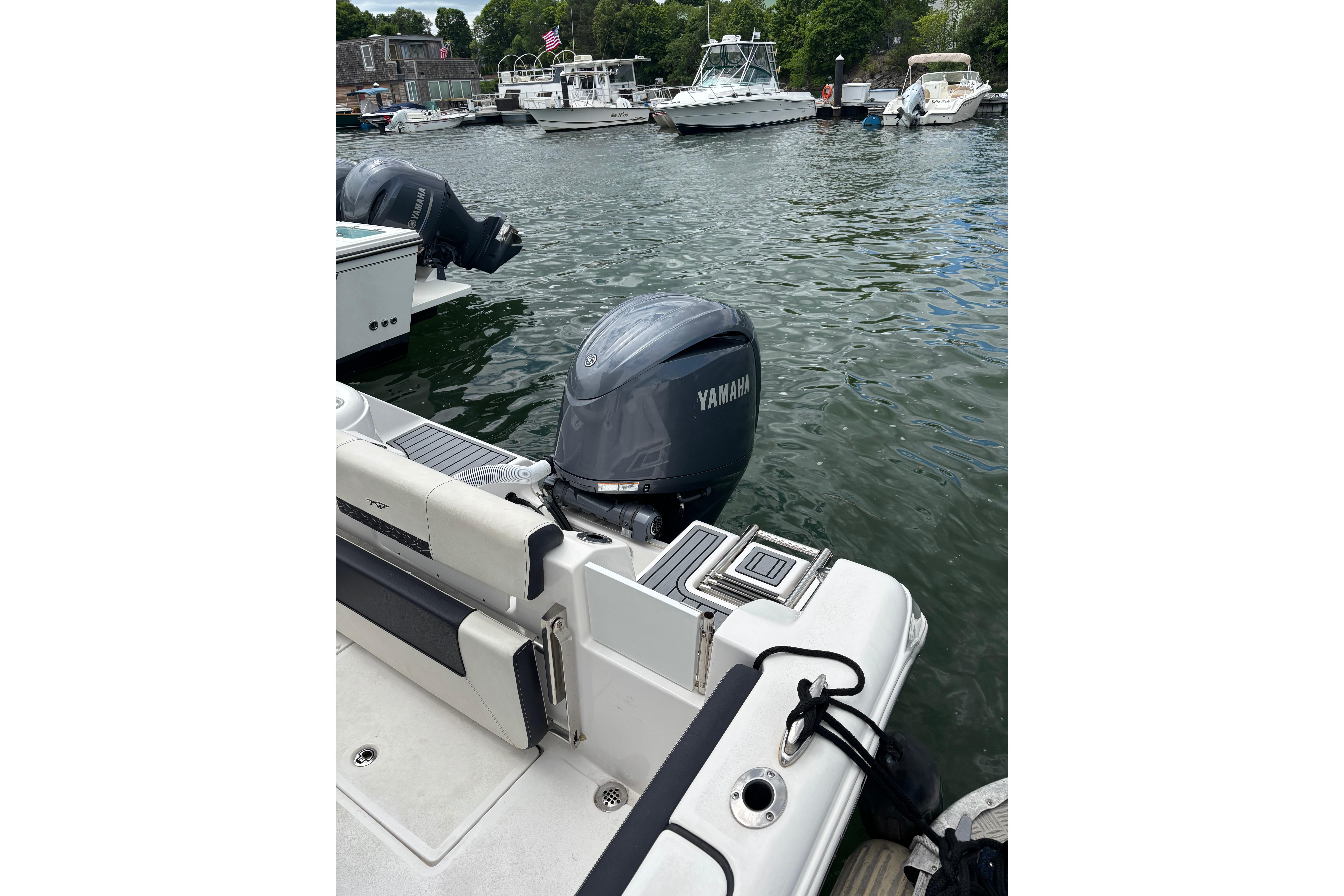 2024 Tidewater 220 CC Adventure boat with Yamaha outboard motor docked in marina.