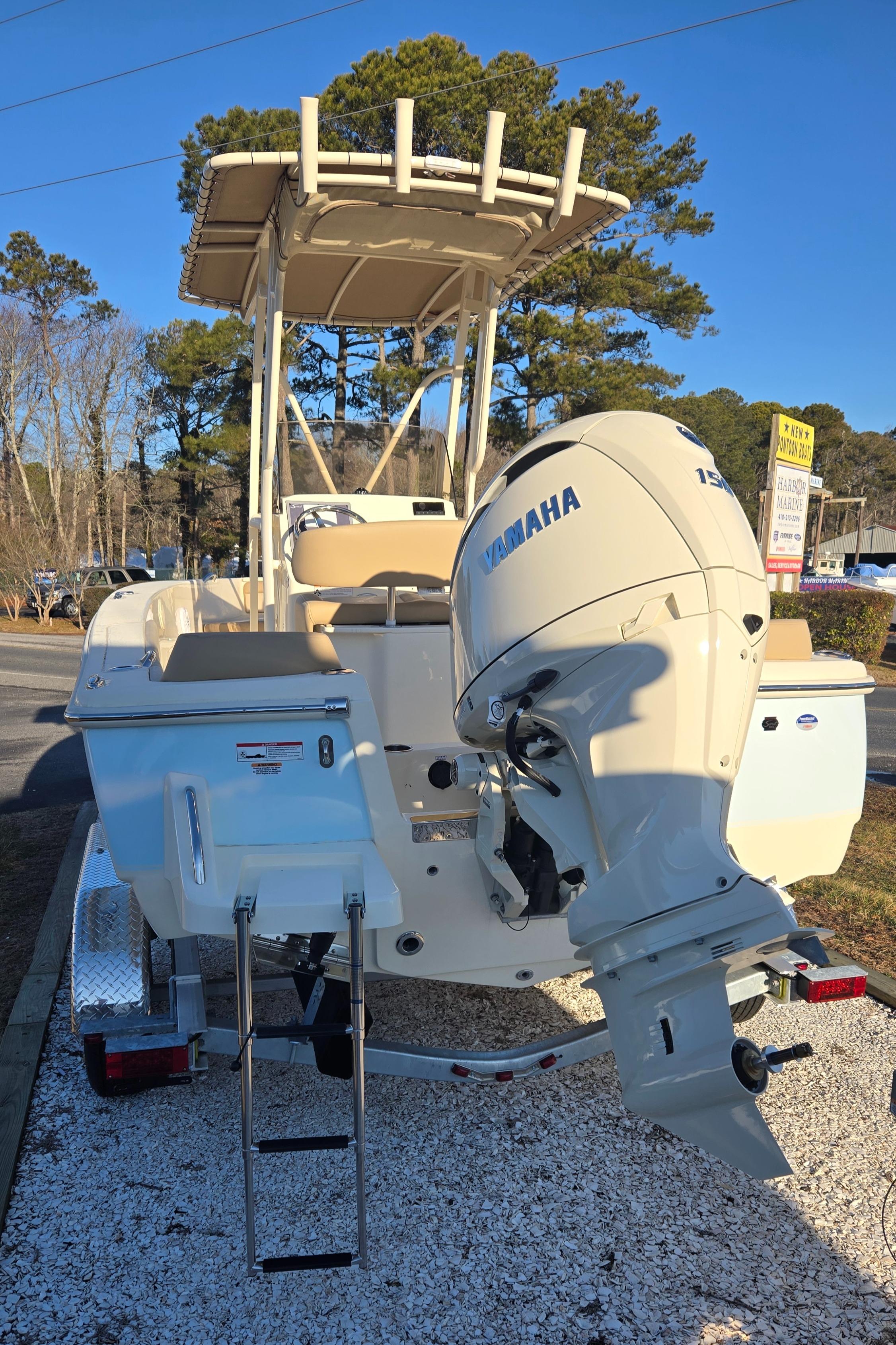 2025 Scout 195 Sportfish boat with Yamaha outboard motor, parked on a trailer.