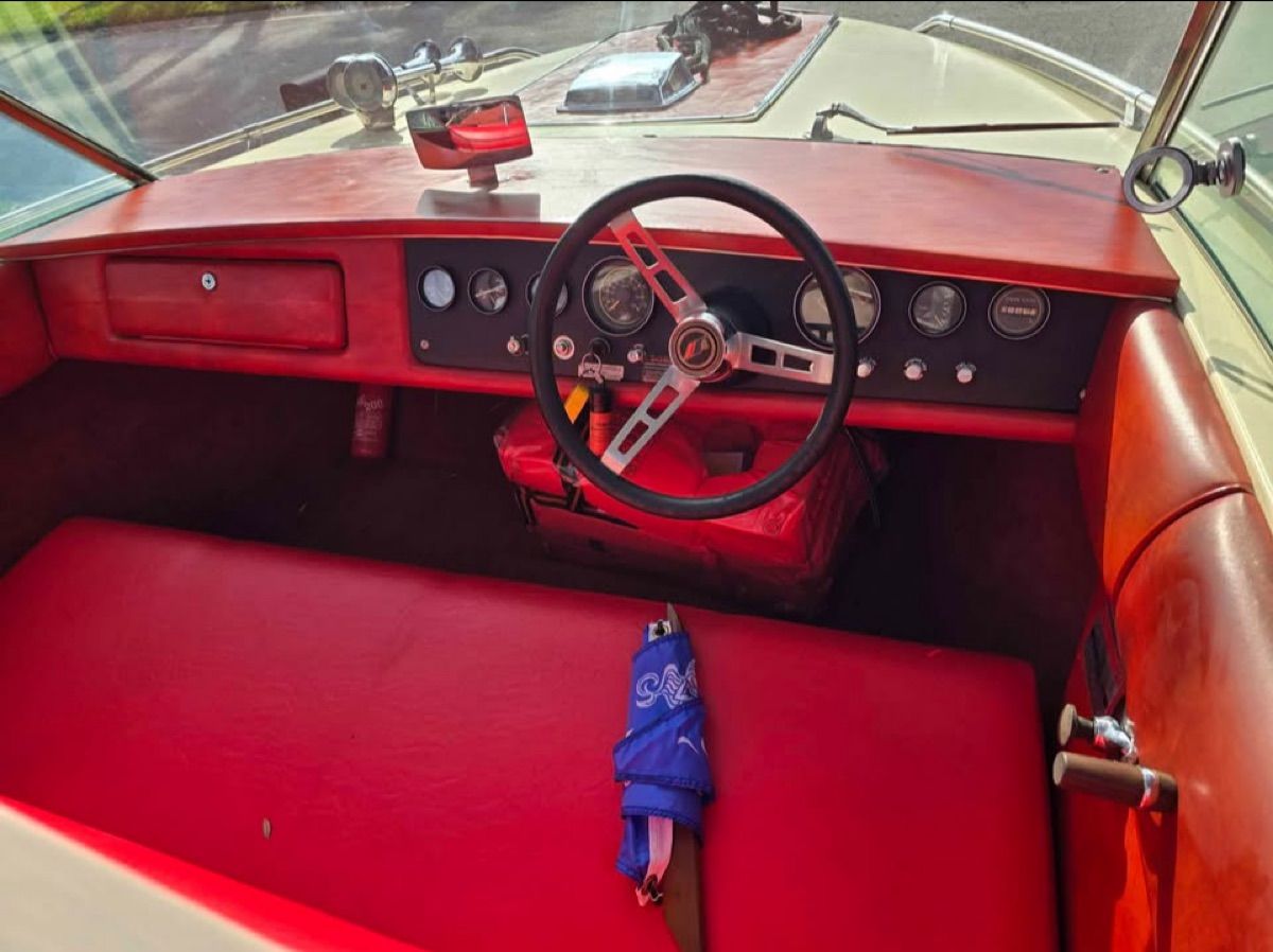 Interior of a 1980 Century Resorter boat with red upholstery.