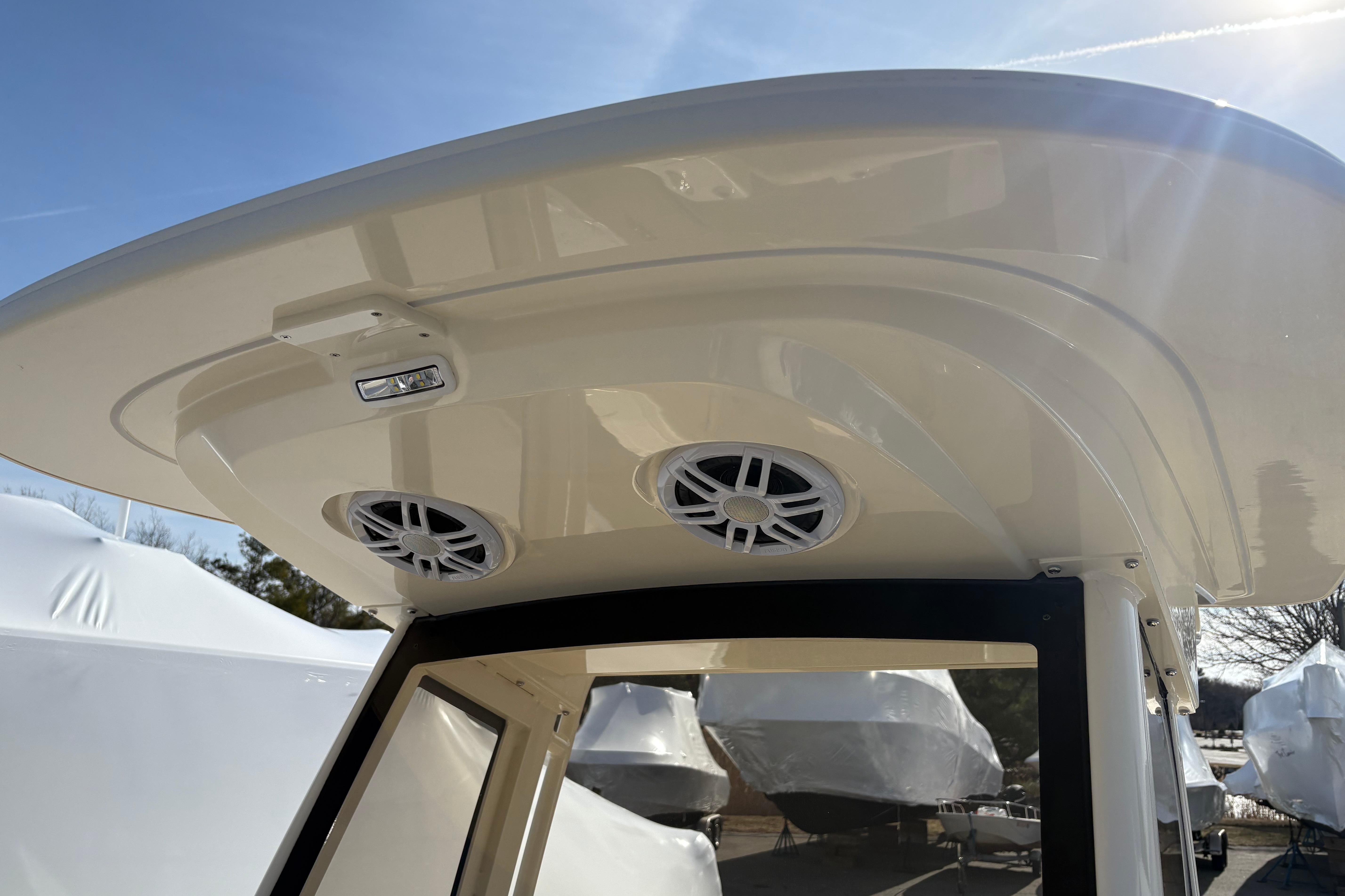 2026 Scout 220 XSF boat roof with speakers and light under clear sky.