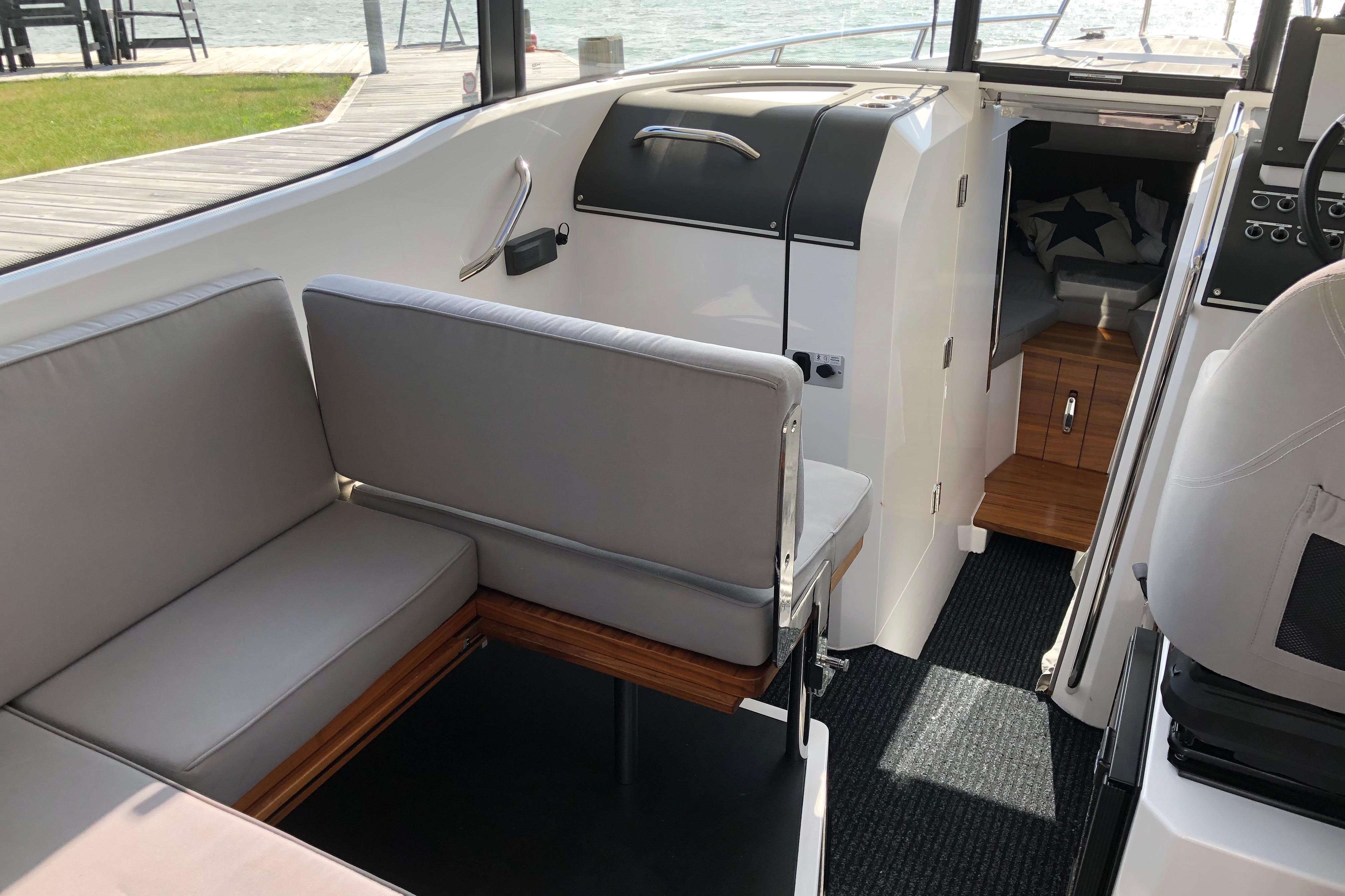 Interior of 2016 XO Boats 270 RS with gray seating and wooden accents.