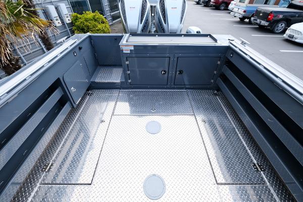 2024 Hewescraft 250 Explorer boat deck with storage compartments and diamond plate flooring.