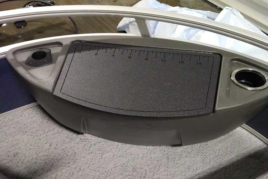 2026 Sun Tracker Bass Buggy 18 DLX boat console with ruler and cup holder.