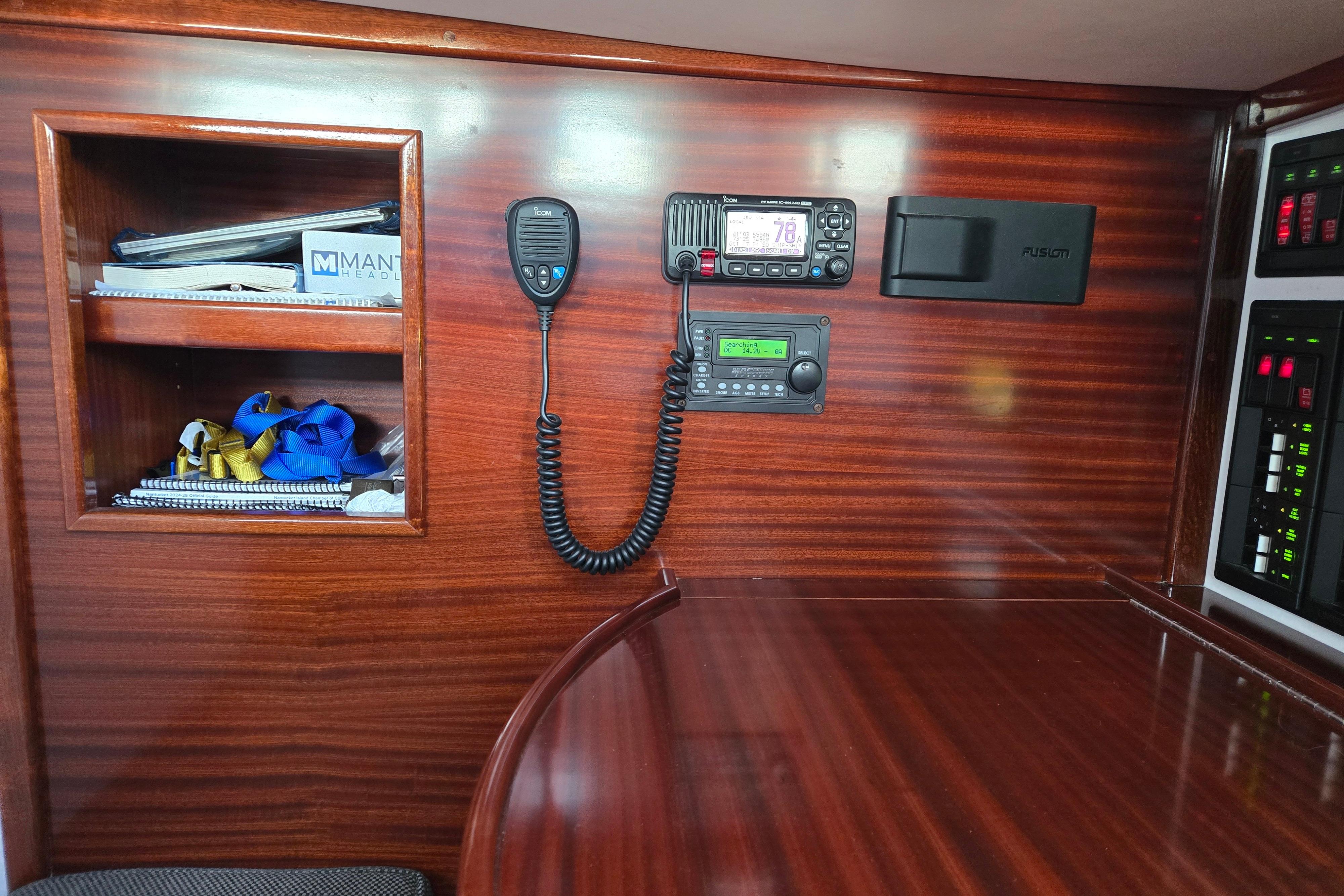 Interior of 1970 Hinckley Bermuda 40 yacht with radio equipment and wooden shelving.