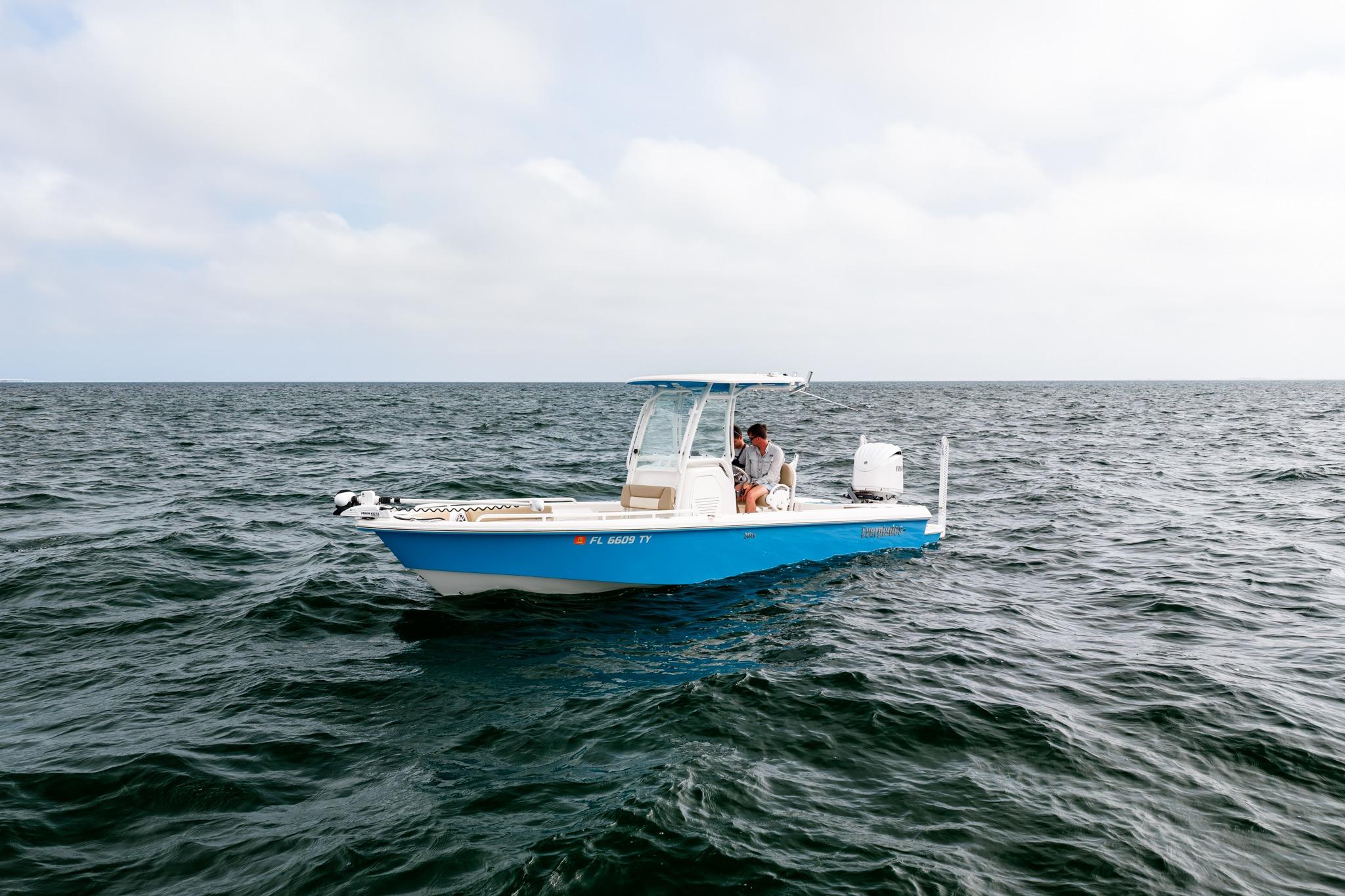 2023 Everglades 243 Center Console boat on open water under cloudy sky.