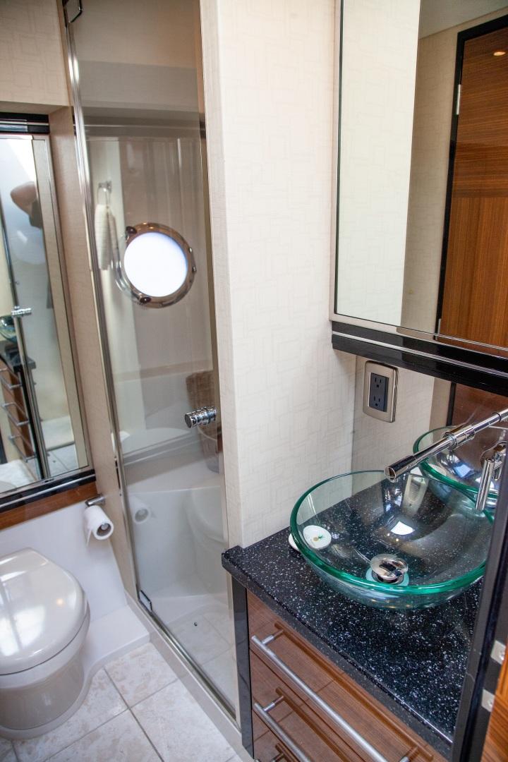 Luxurious bathroom in 2009 Marquis 500 Sport Coupe yacht with glass sink and shower.