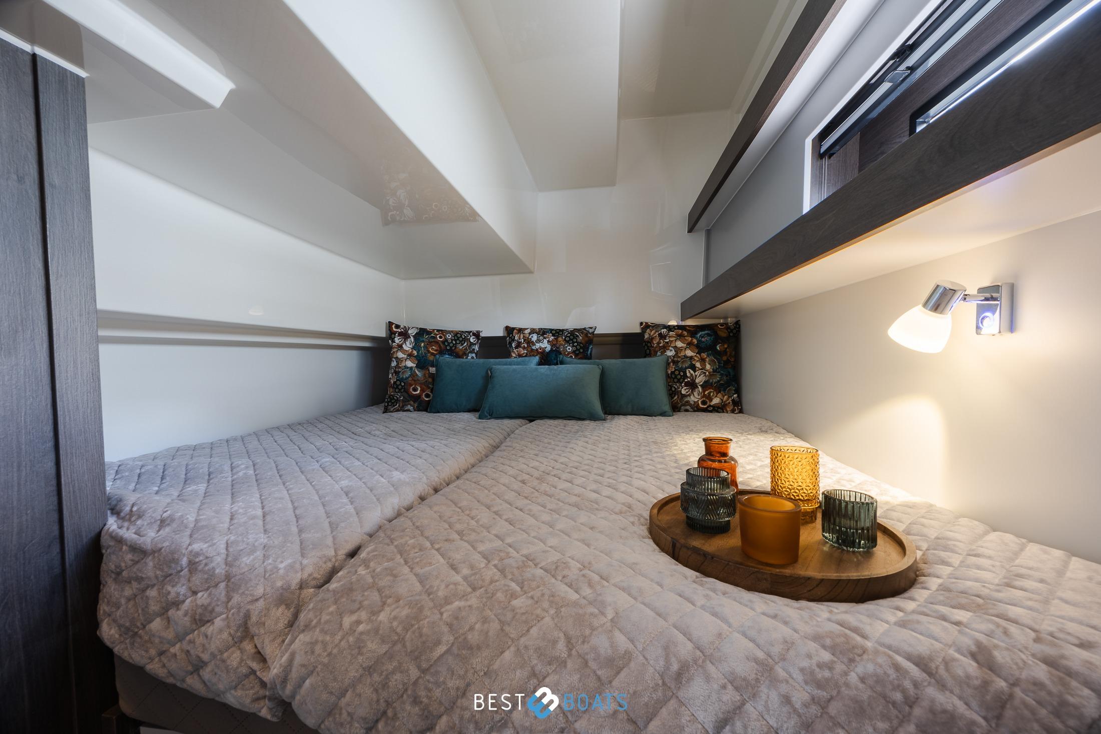 Luxurious cabin interior of 2023 Cobra Yachts Futura 36 Premium Fly, featuring cozy bedding.