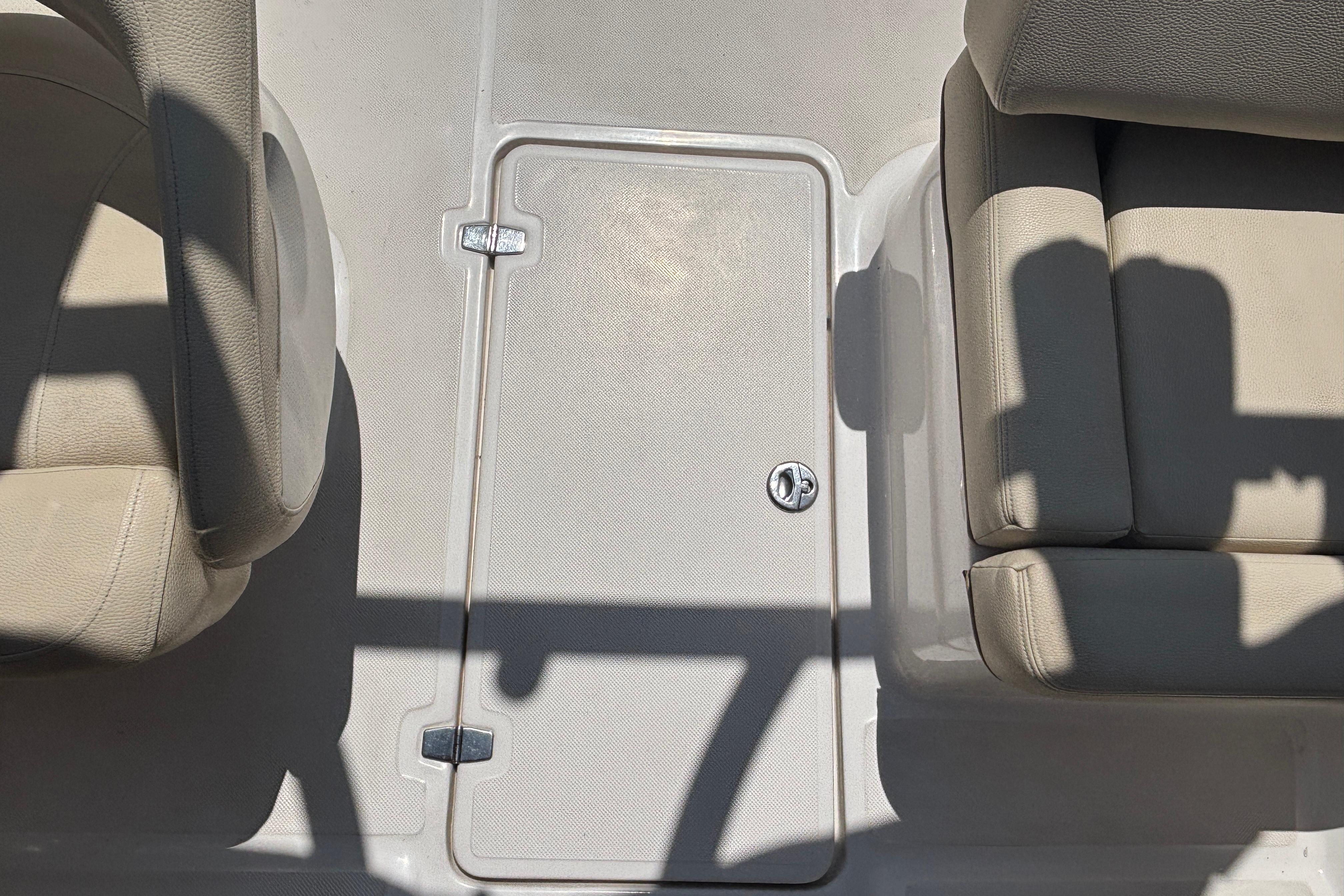 Interior of 2018 Regal 1900 ES Bowrider showing seating and storage compartment.