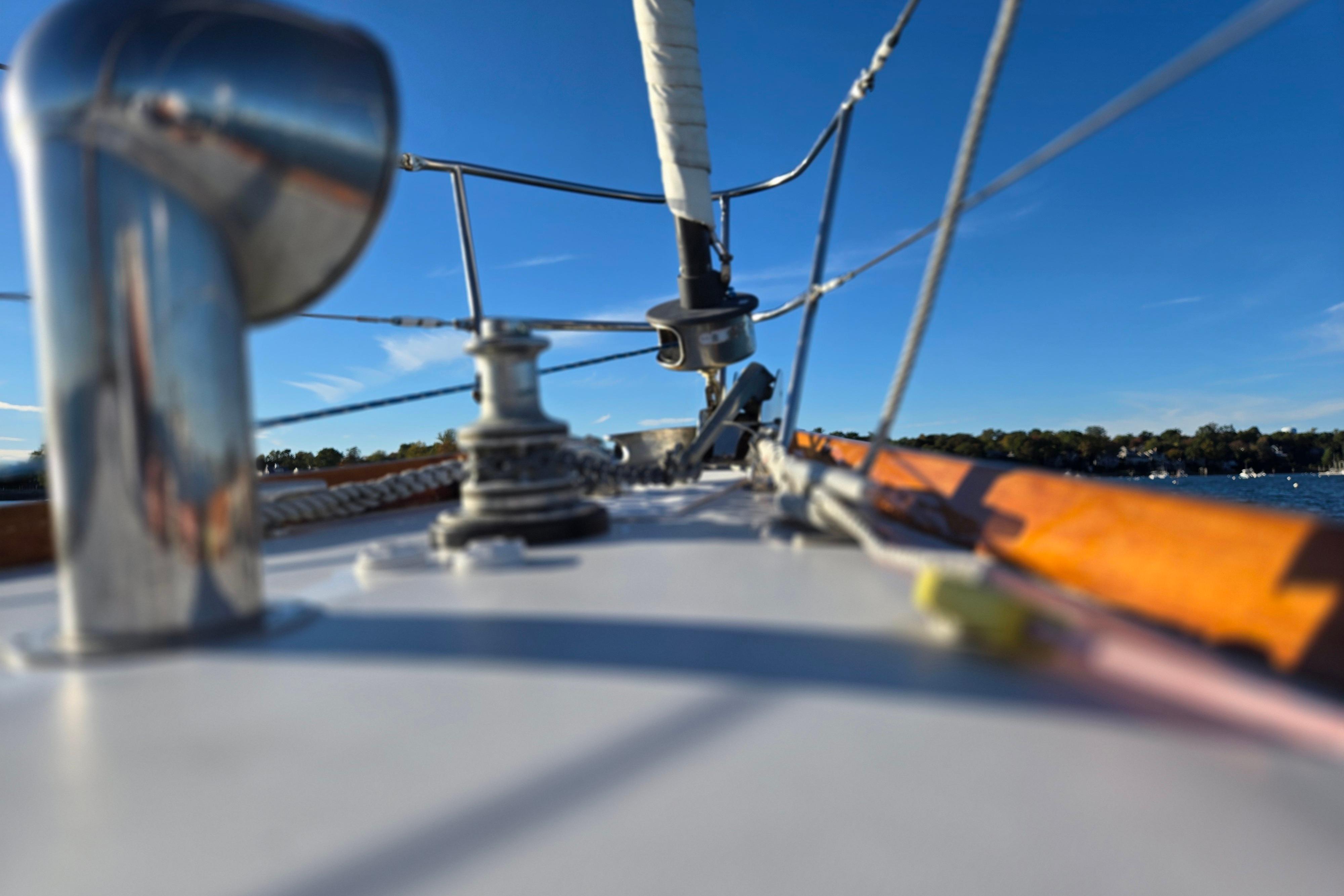 Deck view of a 1970 Hinckley Bermuda 40 sailboat under clear blue skies.