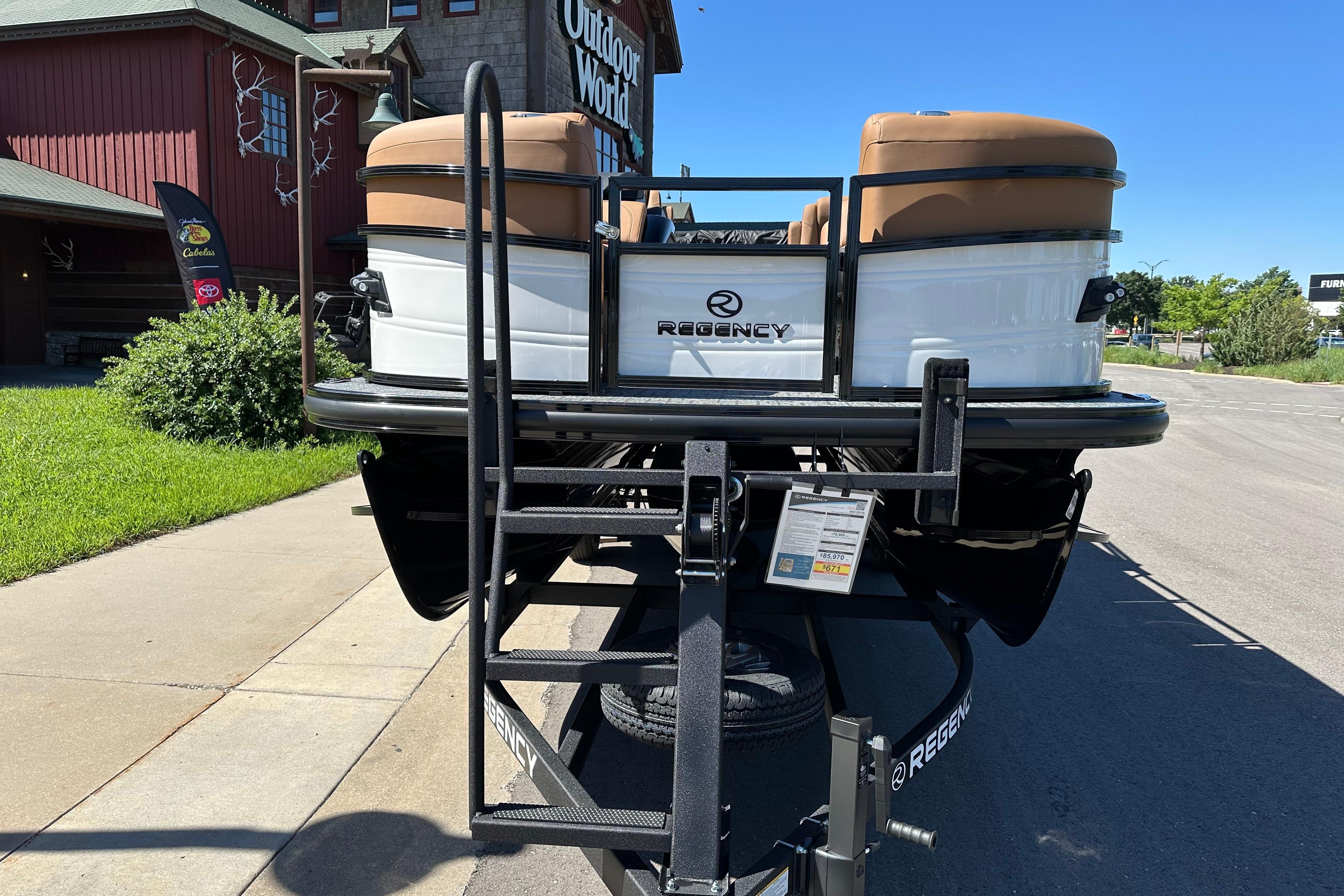 2026 Regency 230 DL pontoon boat on trailer, outdoor setting, sunny day.